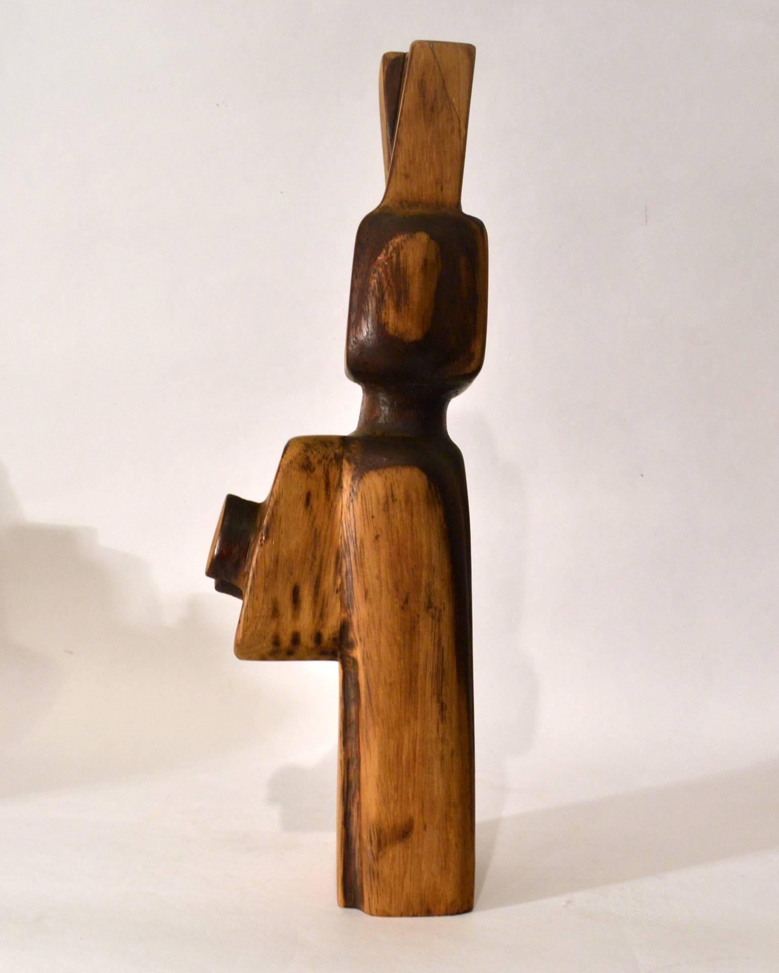 Abstract female figure carved in wood and part coloured. The sculpture is inspired by the African art and Cubist artist like Picasso in the 1920s and made in 1978 by the Dutch sculptor and teacher Bert van Beek (1946), working in Rotterdam.
 