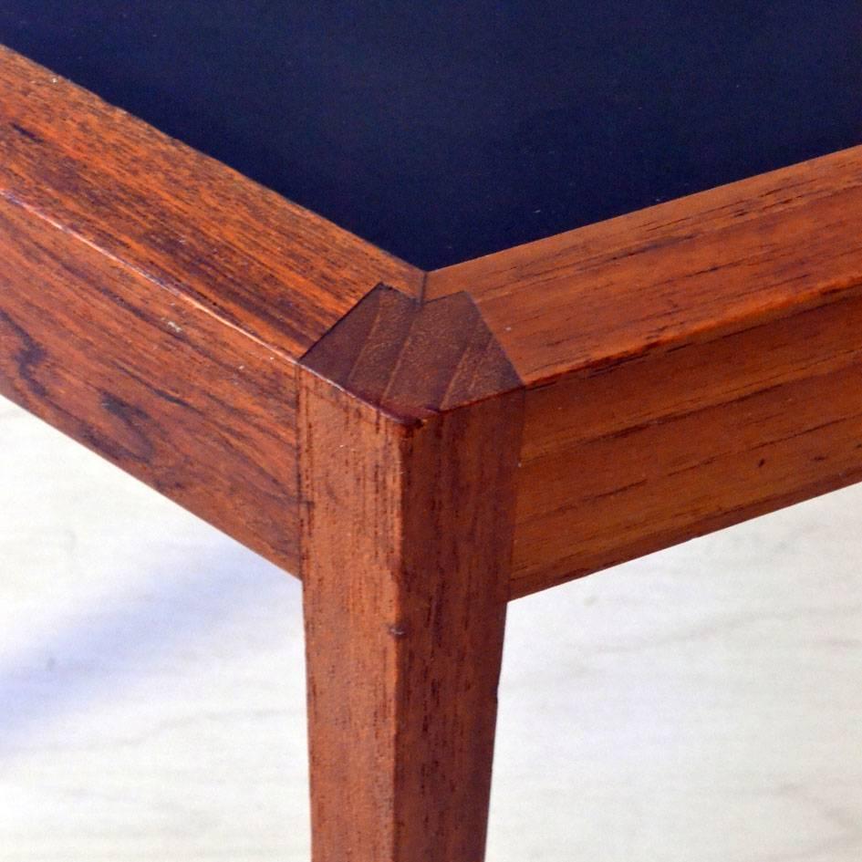 A hexagonal teak side table with a black Formica top with refined joinery by Hans Andersen for Artek, Denmark, circa 1959. The underside is stamped with the maker's details and 