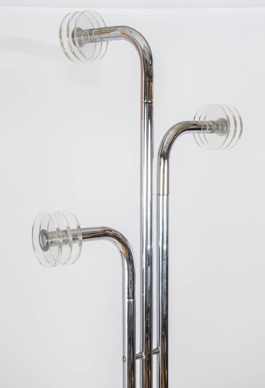 This freestanding coat stand has three chrome arms with Perspex hooks and two rings for scarfs stands. The base is Carrara marble black with white and gold veins.