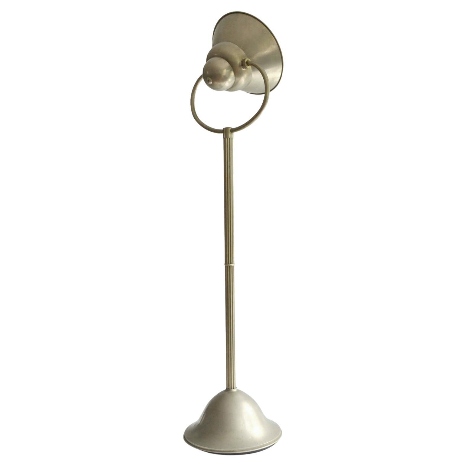 Modernist Art Deco floor lamp with adjustable shade to direct the light up, down or side ways. Functionalist design has a has a reflector finished shade to optimize the light and create indirect way of lighting . This rare and innovative design is