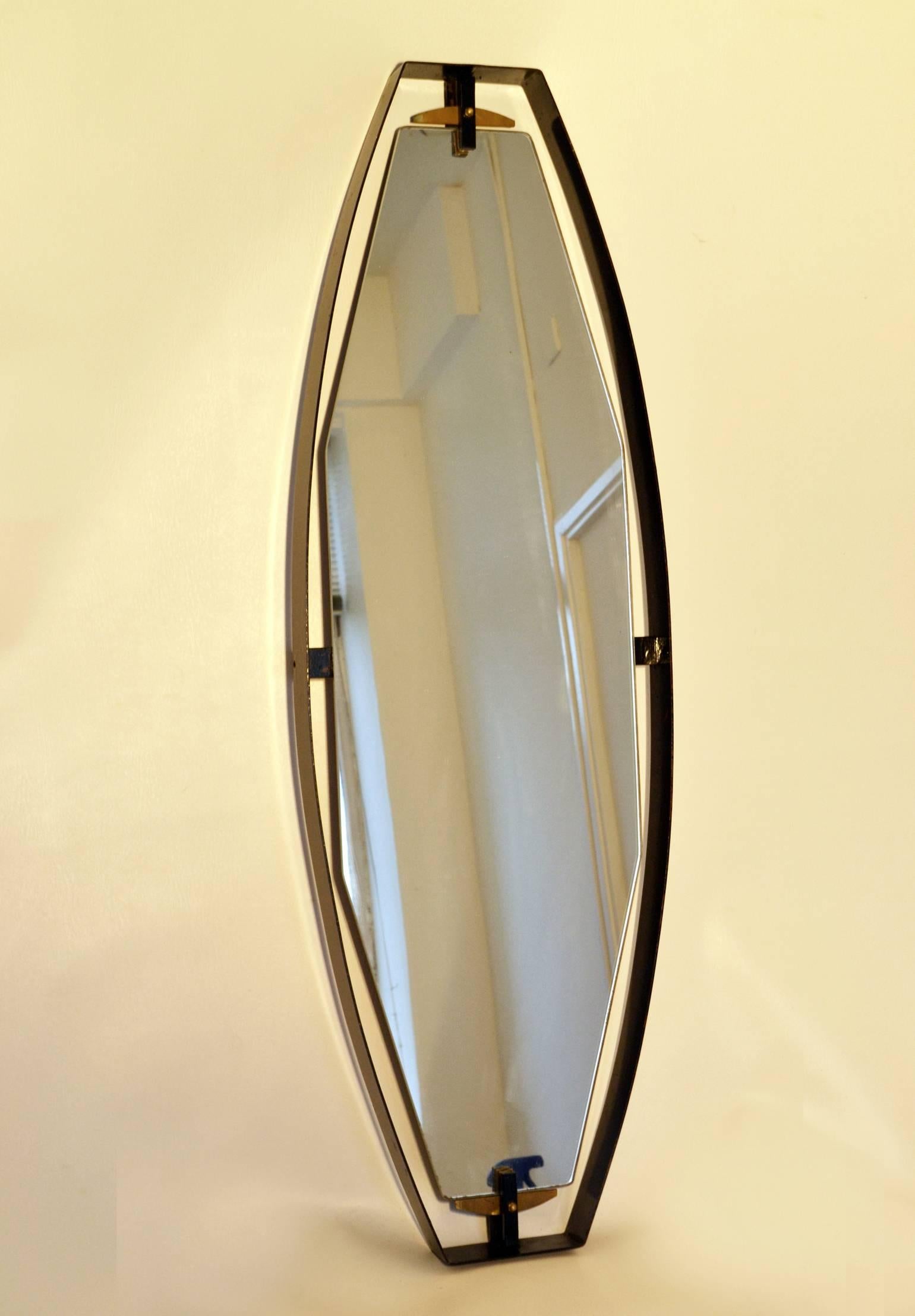 Diamond shaped full size mirrors float in a curvaceous black metal frame. The sculptural form is held together by brass and metal fittings details from above and below. The glass is original and marked.
The black border is re-powder coated.