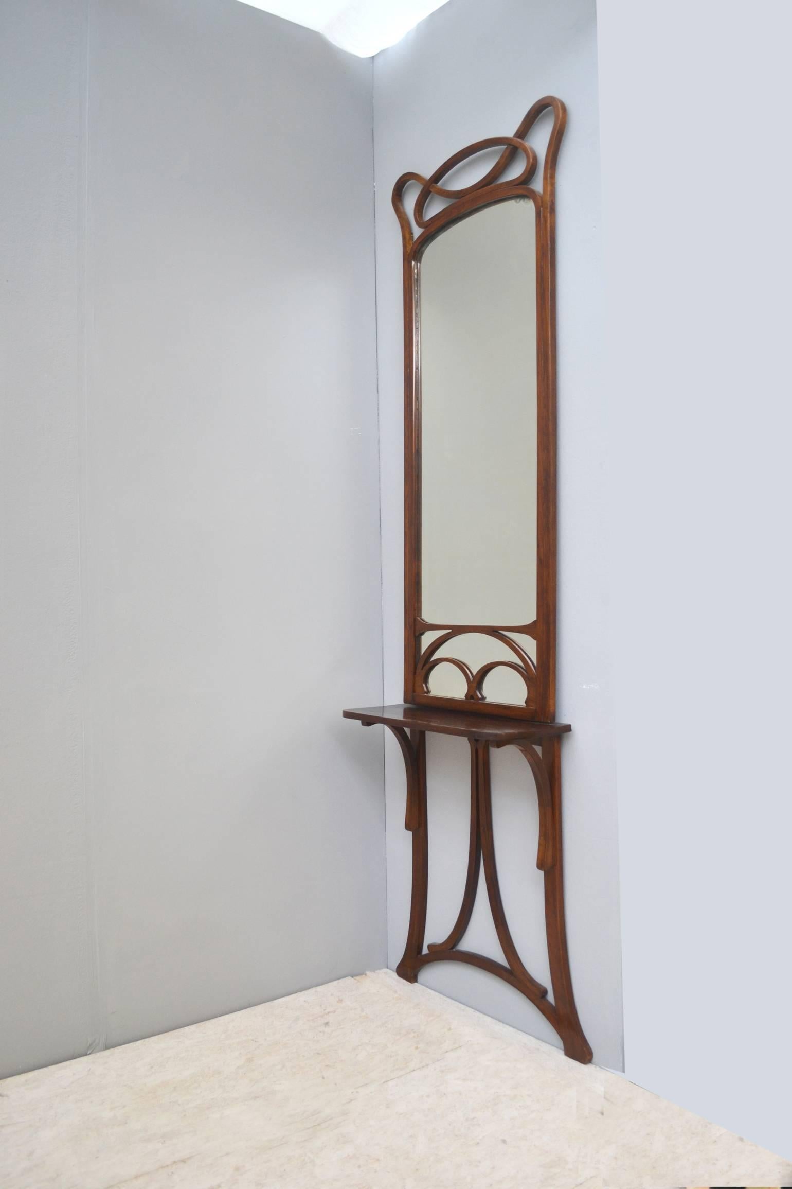 Original Viennese beech bentwood hall mirror with console stand.
The mirror has some minor oxidation to small areas to the lower side and top edges, but only adds character and confirms age and originality.

Thonet label is placed on the