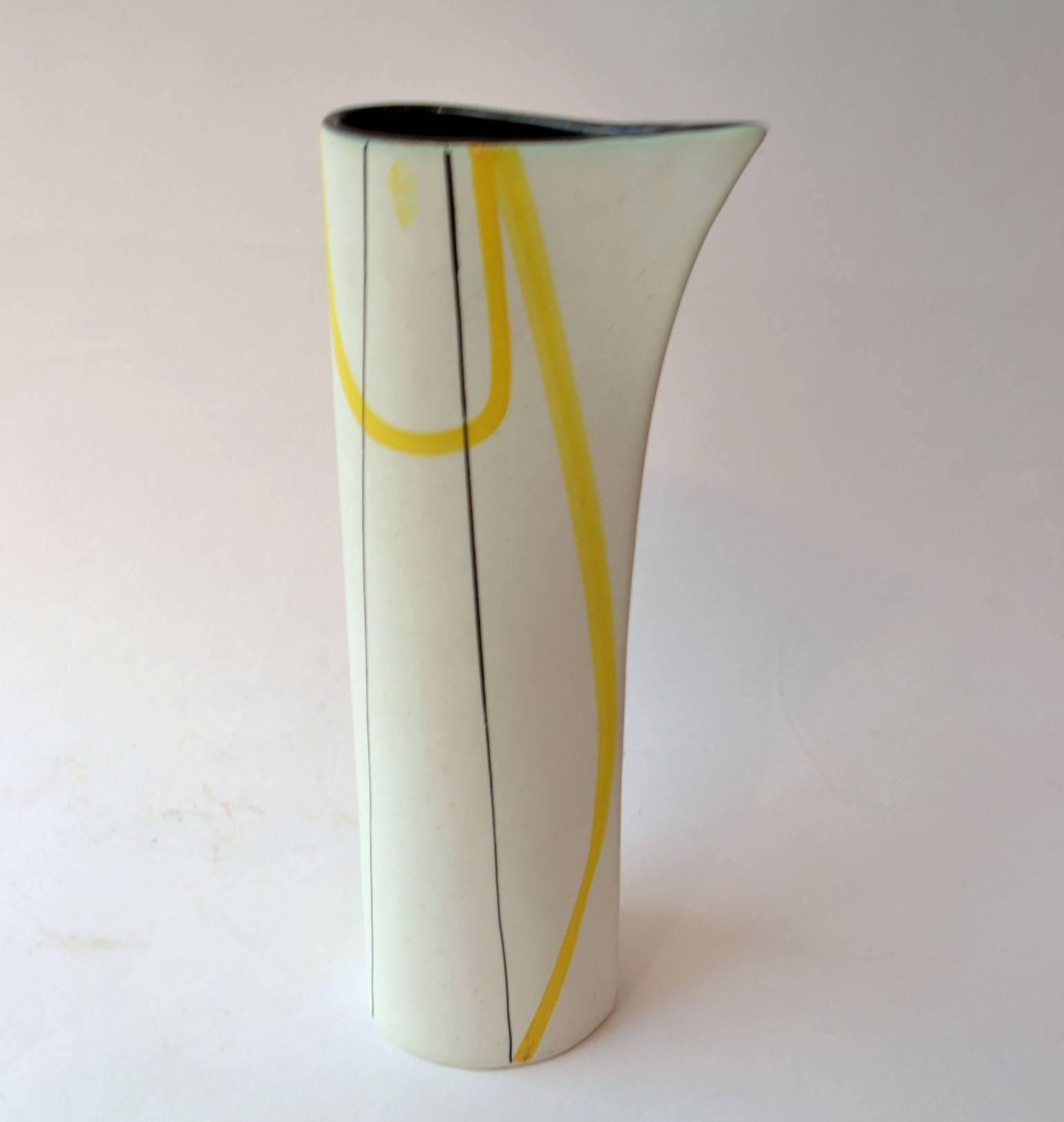 This white jug sculptural in its form is decorated with yellow and black curvaceous lines typical for the 1950s.
The jug is made in the famous ceramic destination Vallauris, France.