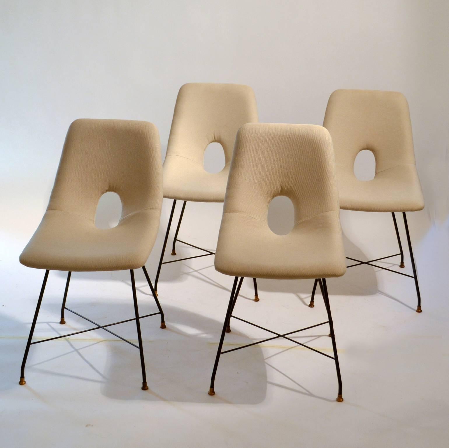 Complete set of six modernist dining chairs, model Cosmos. Italian design by Augusto Bozzi for Saporiti, Italy, 1950s contains a pair of armchairs (width 68cm) and four chairs (width 42 cm) on black steel frames with brass feet. The seats are
