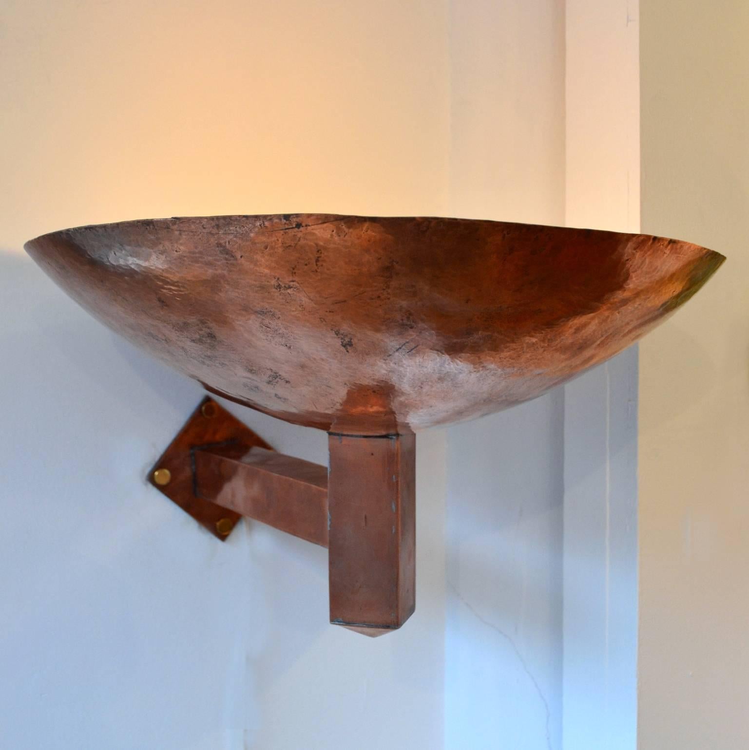 Hand beaten and formed large dish creates an uplight effect. They are in the style of School of Amsterdam and came from a public building in the Netherlands.