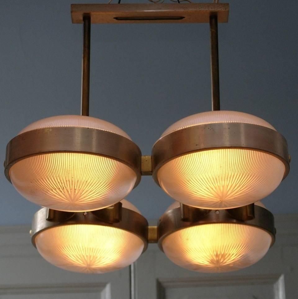 Gamma chandelier with four lights designed by Sergio Mazza for Artemide Italy, circa 1960 Italy. Executed in nickel, brass and pressed opaline radiant striped glass. The ellipse shaped shades are connected by curved brass strips. This rare early