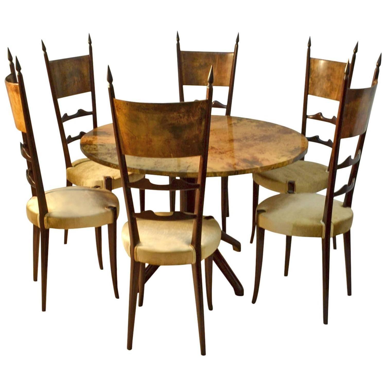 Exquisite 1950s high back dining chairs that have a regal quality.
The back panels of the chairs are in goatskin or parchment and the frames are ebonized wood. They are reupholstered in beige silk velvet.
They are in excellent condition.
There is