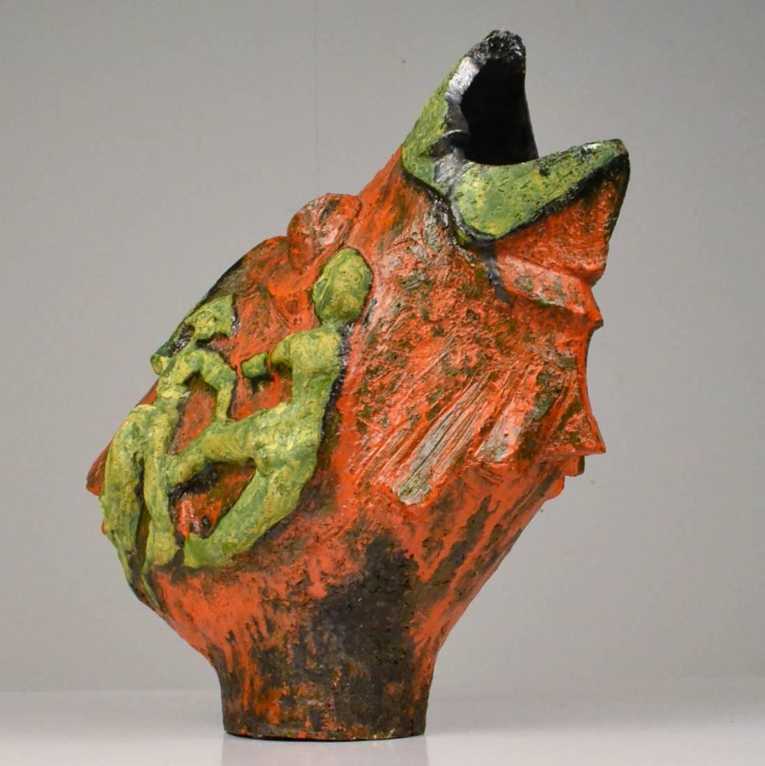 Expressive hand sculpted bird sculpture decorated with dancing female figurines on both sides, in orange and green glazed ceramic is signed A. Smit 1971, Netherlands. This hand formed ceramic sculpture is in the style of the famous Dutch Cobra