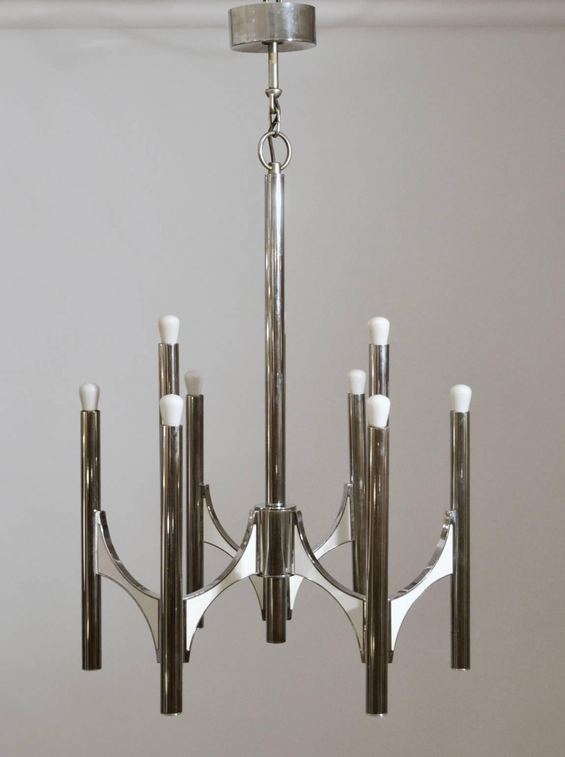 Minimalist chrome nine arm chandelier with nine lights and cream metal plates by one of the leading Mid Century lighting designers Gaetano Sciolari, Italy, marked with the original label in the ceiling rose.
