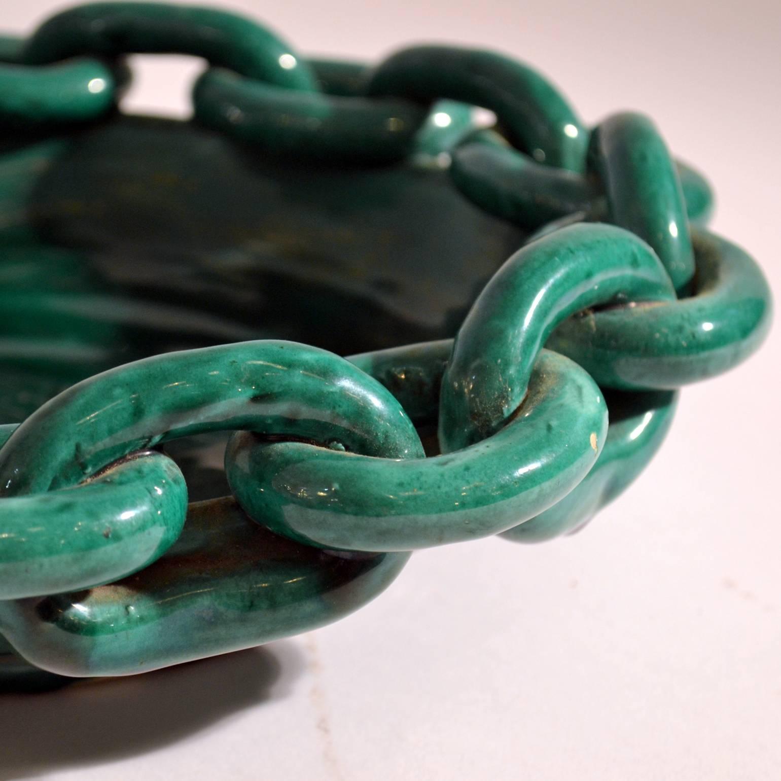 Hand formed emerald green glazed French fruit bowl signed Vallauris, decorated with a ceramic chain around the edge.
There are various bowls available. See images below.