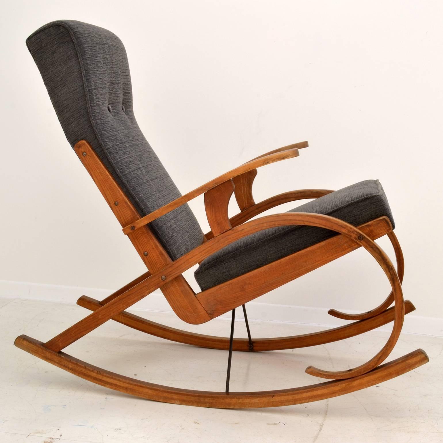 Czech 1930s rocking chair with frame in bent oak wood with strong lines, reupholstered in a warm grey fabric of the period.
The chair is extremely comfortable, great back support and sublime movement for active sitting or
