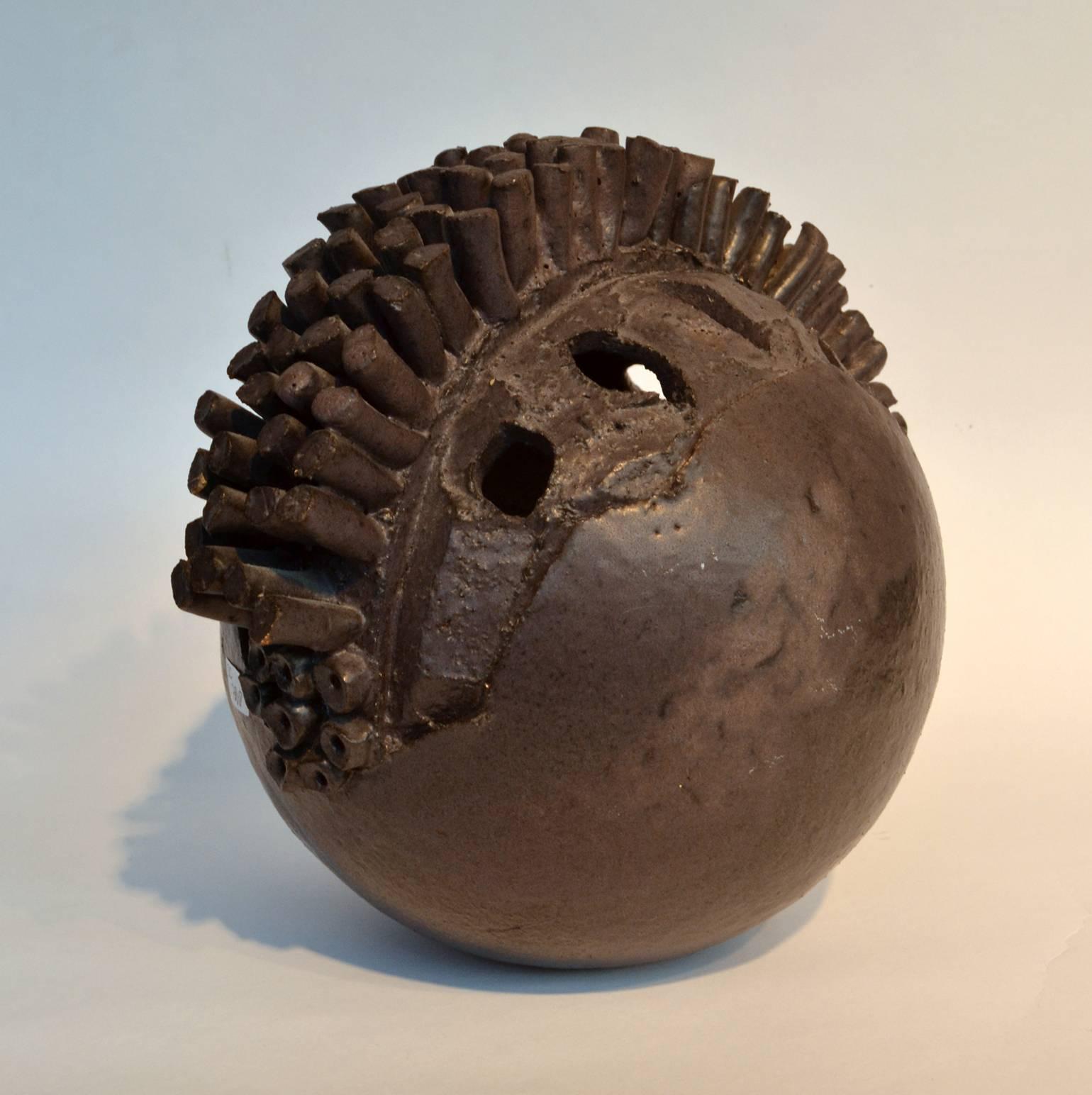 Abstract ceramic sculpture, ball shape with an array of extended forms and perforations, finished with a matt nearly black matt glaze. This unknown German studio potter has signed this piece with 'H'.
