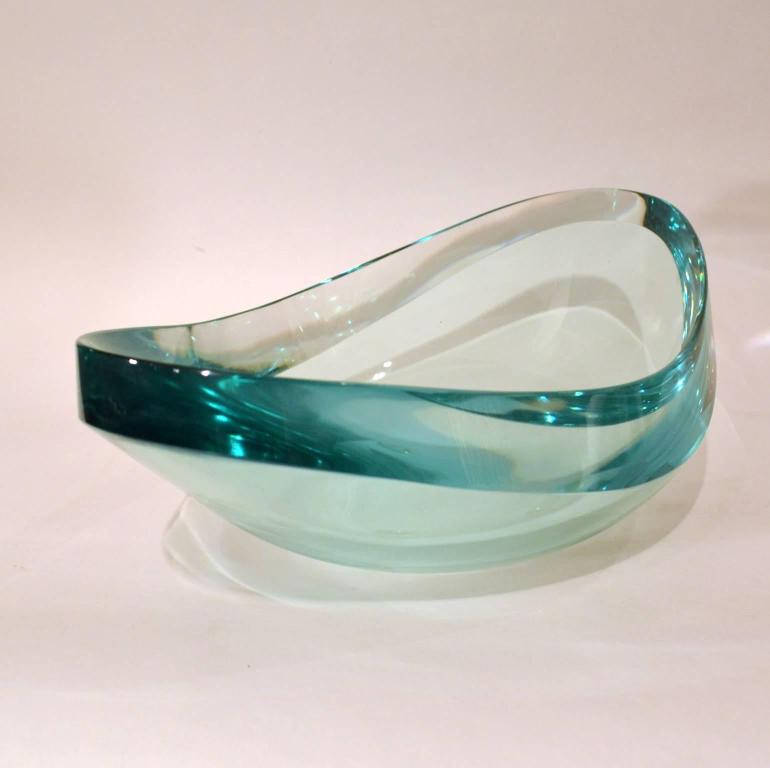 Exceptional large oval crystal glass bowl with a flat polished edge in the typical green reflecting clear glass, the signature of Fontana Arte, Italy 1960s. Made by the Murano glass masters Erwin Burger and signed EB. The bowl has a wonderful