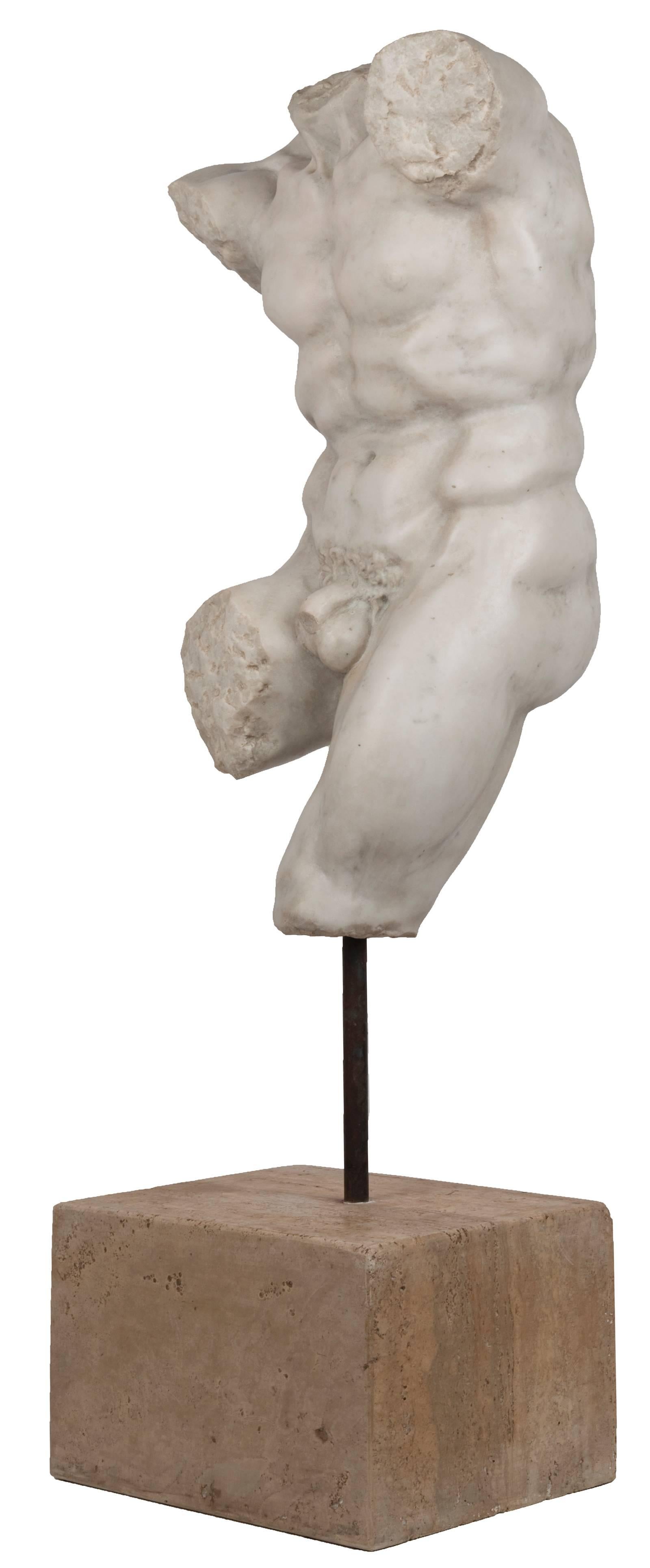 A beautifully carved white marble torso of a man on a marble stand. Though the fragment lacks the head and most of the arms and legs, the well-formed piece maintains the strength and sense of movement, arms outstretched and leg raised, of the
