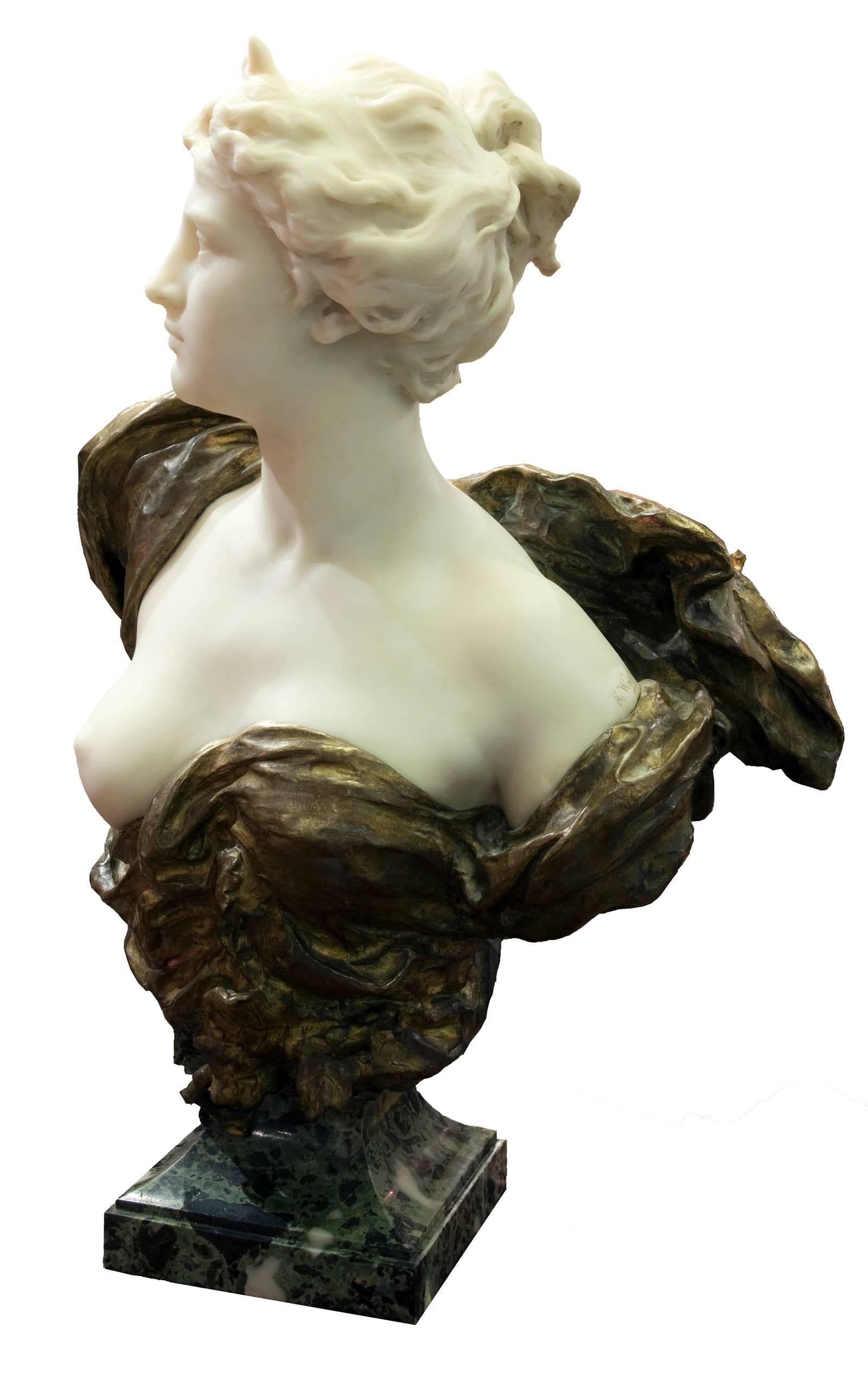 Diana, gazing stoically into the distance and depicted with the crescent moon diadem upon her head, is delicately rendered in this marble bust; the pure white marble juxtaposed against the flowing gilt bronzed drapery that wraps around her
