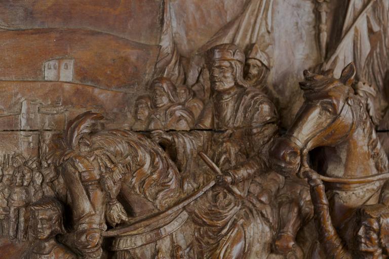 Carved in deep relief and fine detail, this wooden panel depicts a scene from the Third Crusade: The surrender of Ptolemais to the armies of King Richard I of England and Philippe Auguste of France on 13th July 1191. Inscribed lower right, 