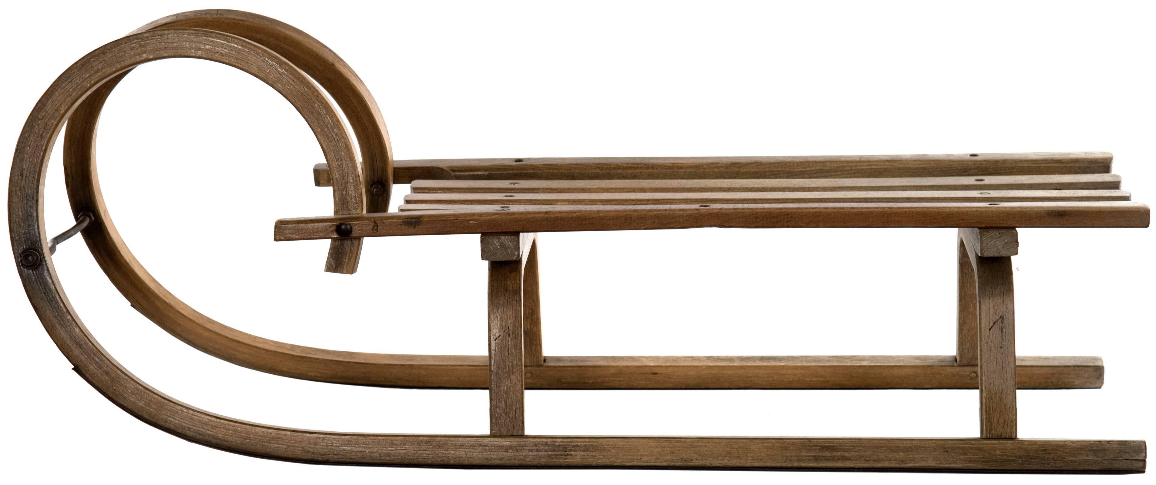 This Classic bentwood design is referred to as a "Grindelwalder", the design originating from the Swiss valley of Grindelwald in the early 1880s. The solid pine construction features three center slates, bentwood brackets, and runners that