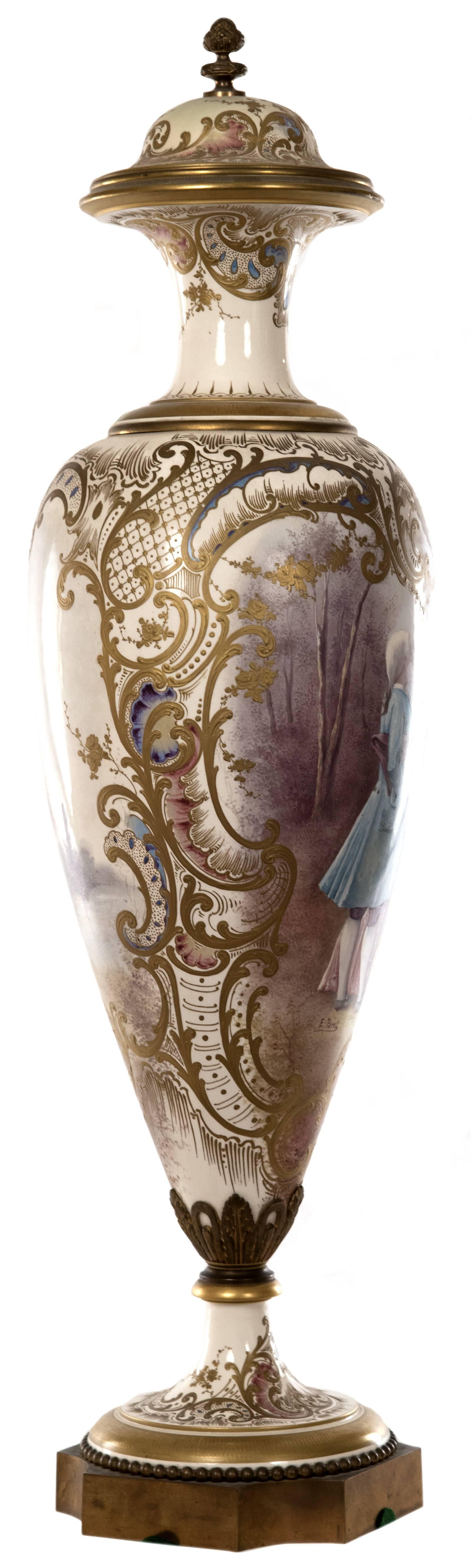 A 19th century French porcelain vase of slim baluster form with slender neck that is decorated with gilded bands and detailed foliate designs, surmounted by a pinecone-shaped finial capping the lid, the tapering and gilt trimmed foot mounted to a