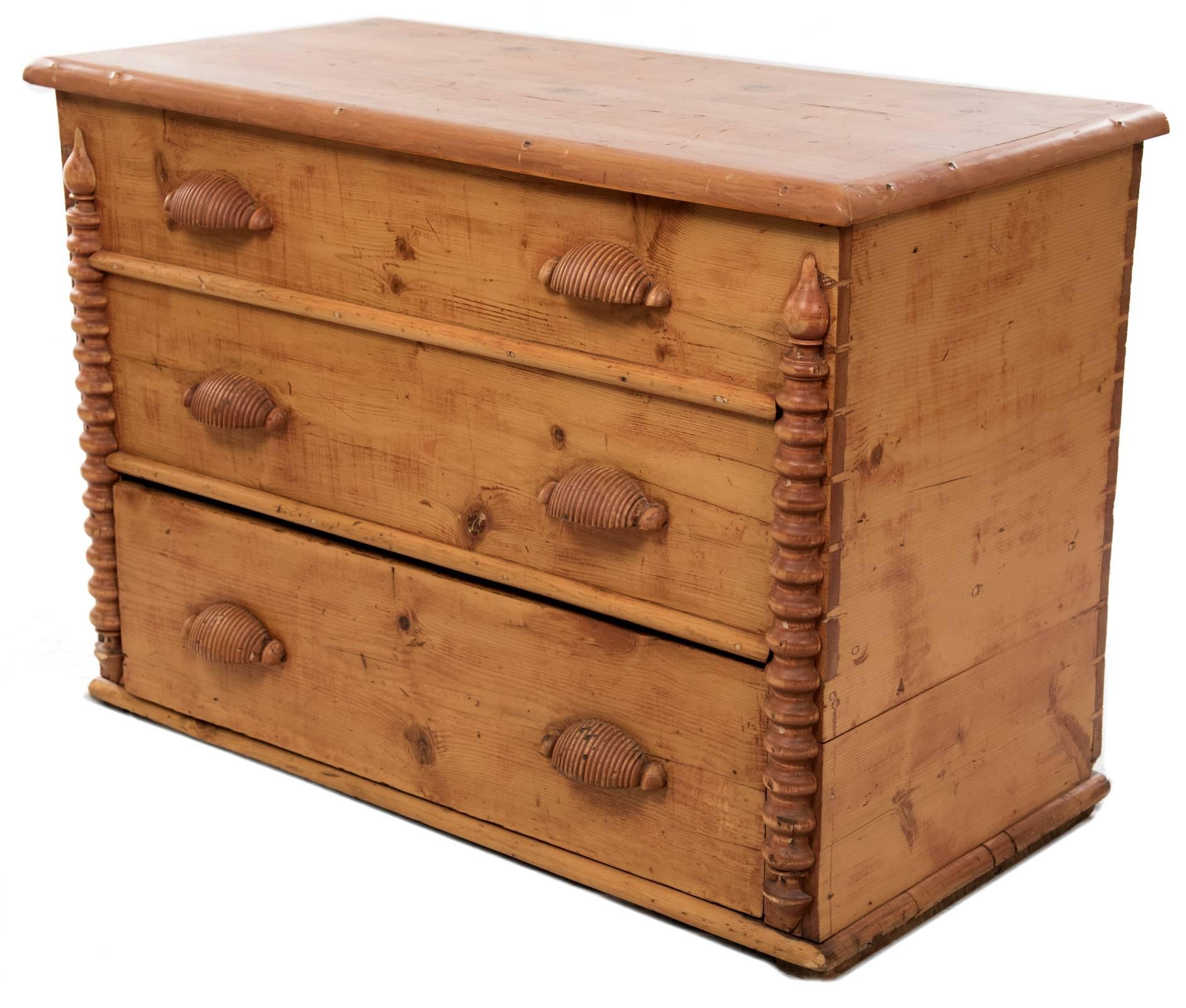 A very rare example of early Mormon Pioneer furniture, with its original pine grain visible and berry veneer, which is created from mixing tree sap with various indigenous berries to create a reddish hue. The mule chest is so called for the