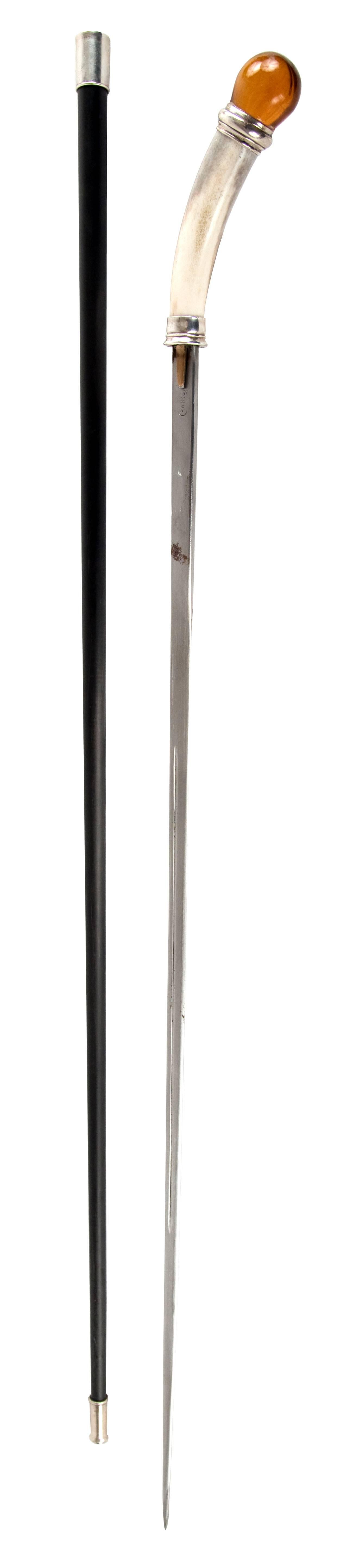 A 19th century sword-cane with a round amber pommel and horn hilt. The blade of the sword, engraved with 