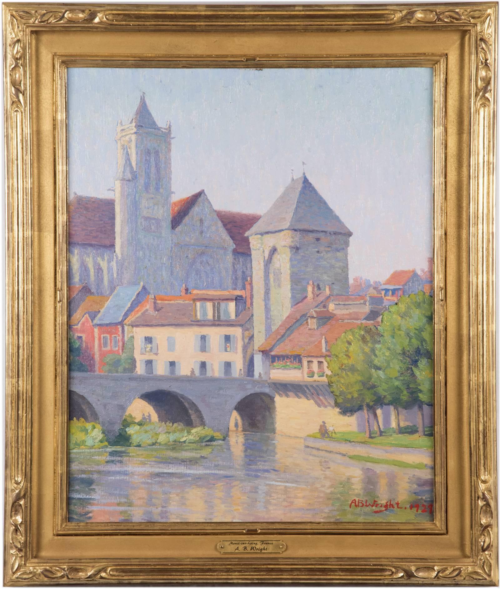 A small French village viewed from the river, the soft sunlight illuminating homes and the village church and an artist painting on the shoreline, is captured in this early 20th century painting by American artist A.B. Wright. The color palette is