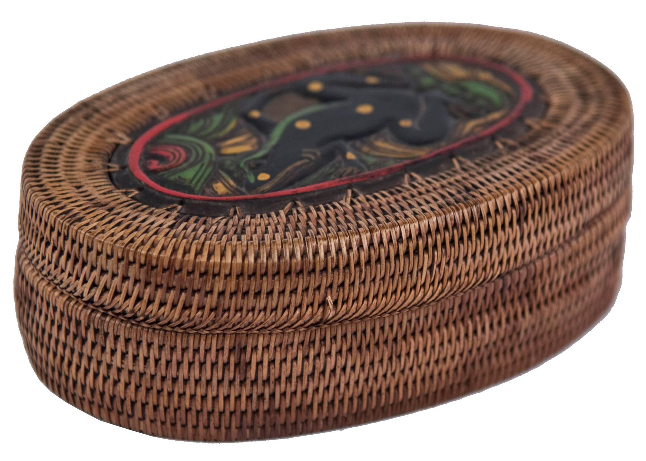 Lidded oval basket box with oval wooden base and central polychrome carved frog motif on lid.