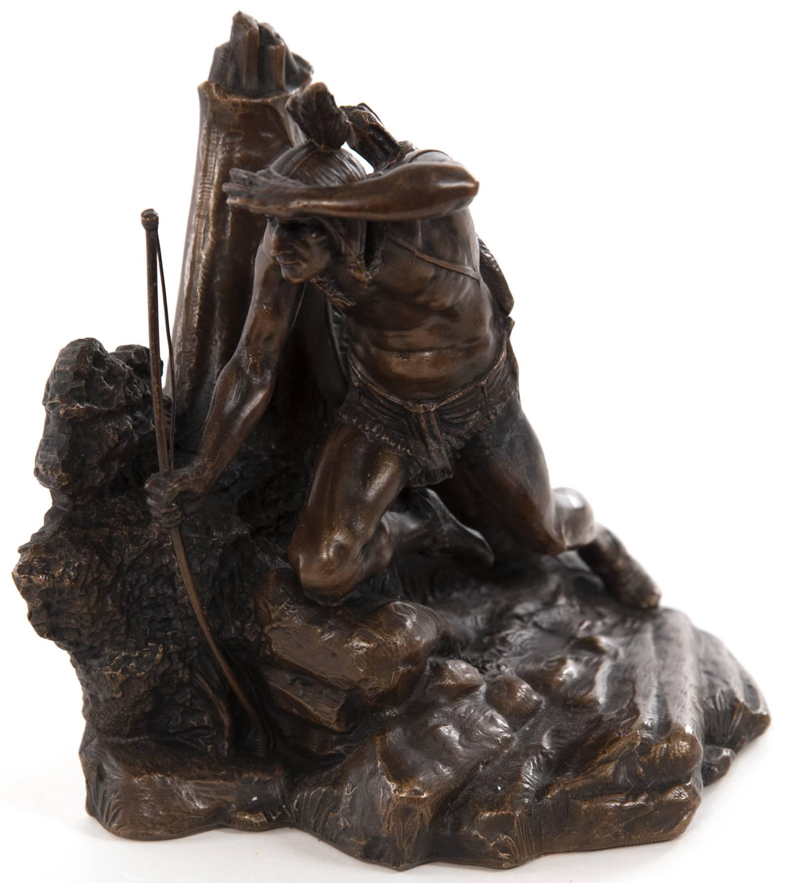 In this pair of figural bookends, an Indian, holding a bow and bowstring, shades his eyes while peering into the distance, one knee resting on a mound and his shield hanging behind him, from his teepee.
Though this pair is unmarked they are