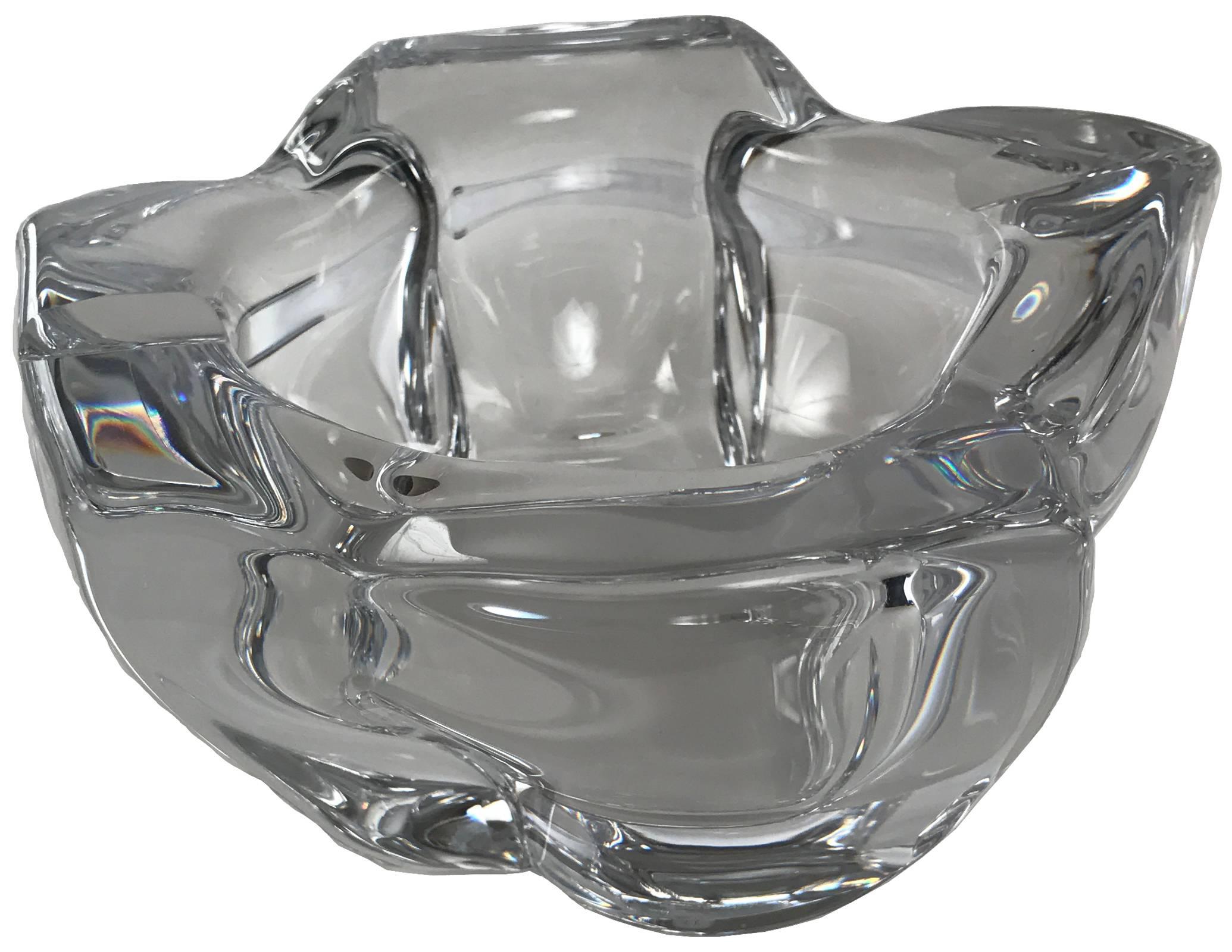 An elegantly substantial French Daum crystal ashtray of abstract, organic form. It is signed on the lower edge 