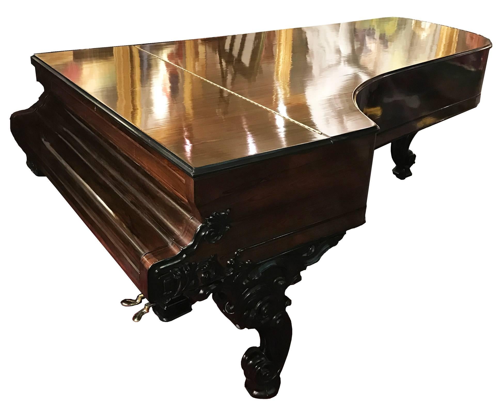 A lovely, fully restored 1866 Steinway & Sons concert grand piano with rosewood case. The elegantly carved Rococo-style scrolled legs and ornate foliate details are ebonized, producing a striking contrast against the case, while the pierced and