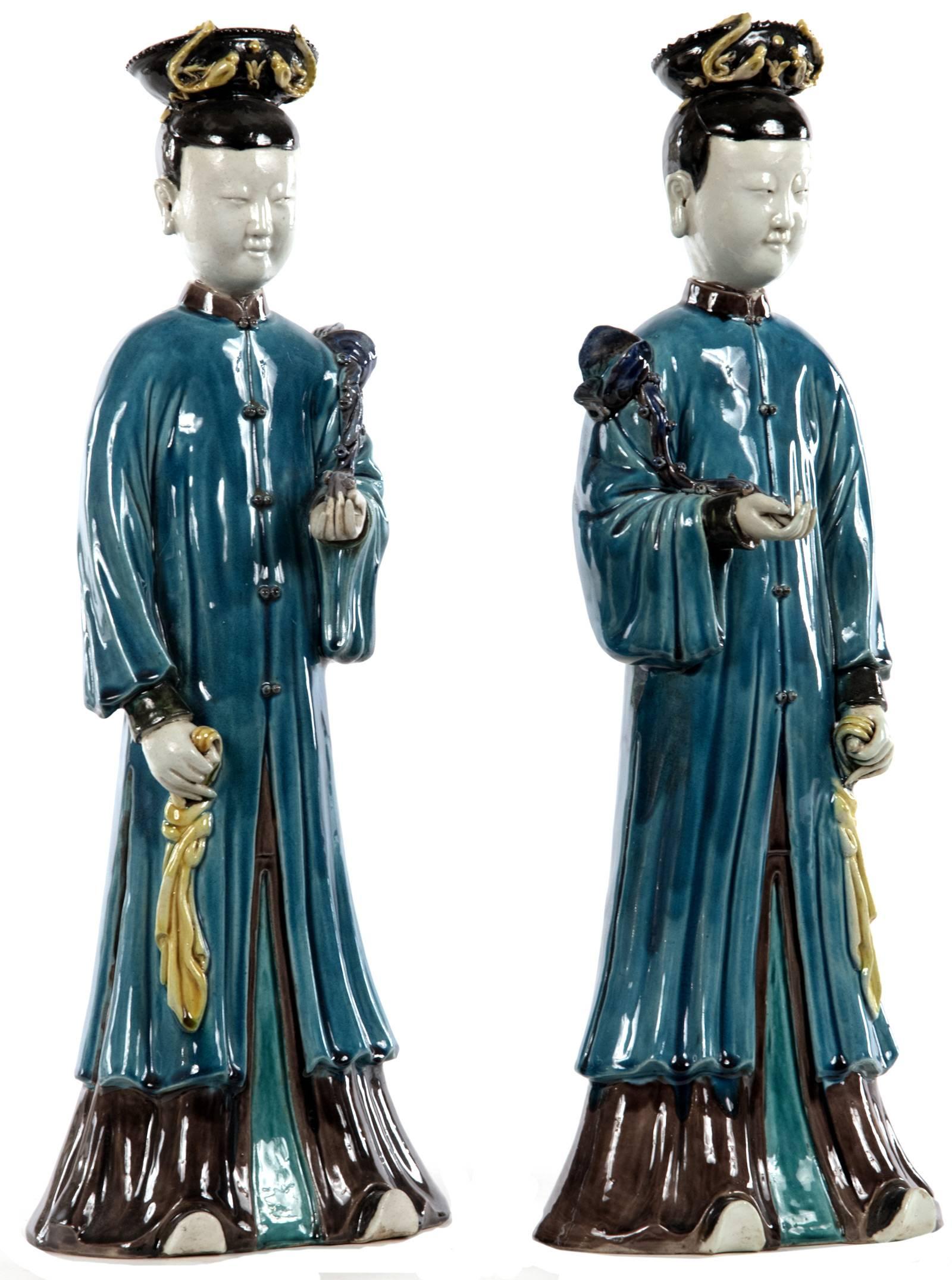A pair of glazed Chinese figurines representing 