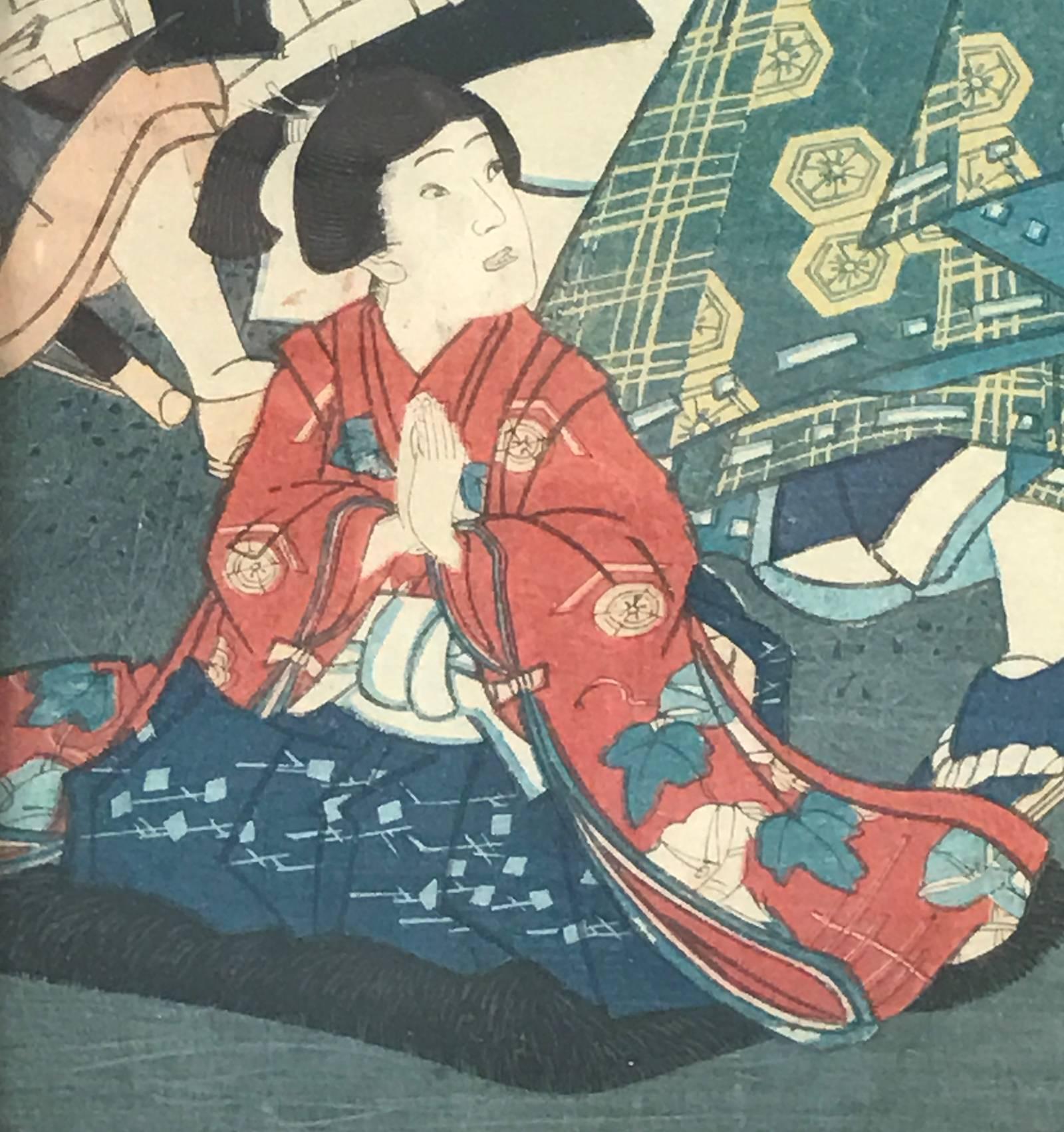 A young girl kneels on the floor with hands pressed tightly together in front of her chest, her head turned to look behind at what appears to be a looming situation- a man wielding a samurai sword is looking angrily upon another warrior who is just