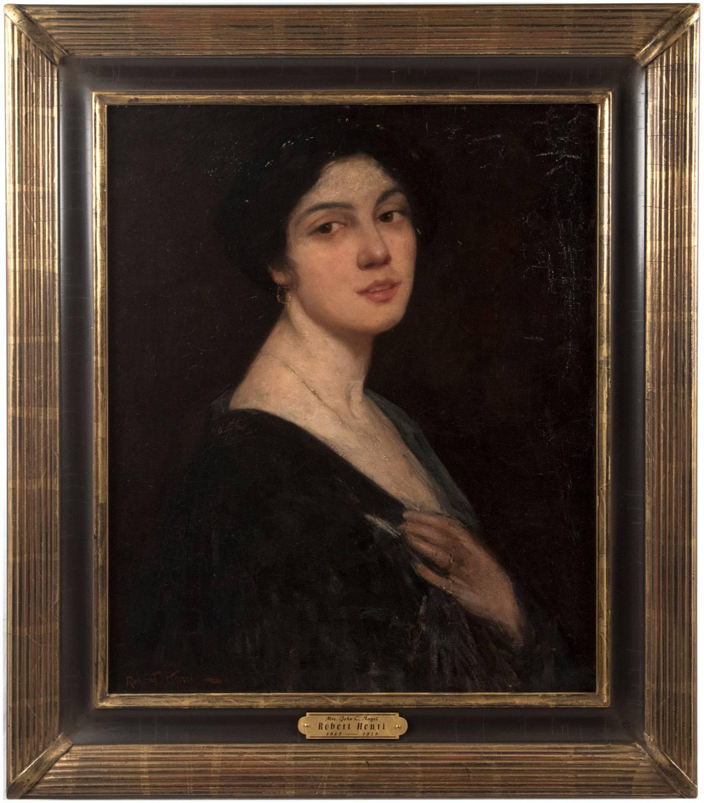 In this early 20th century portrait, by American artist Robert (Cozad) Henri (1865-1929), a woman emerges from a dark background and looks out over her right shoulder toward the viewer, her hand holding her garment closed at her breast as though