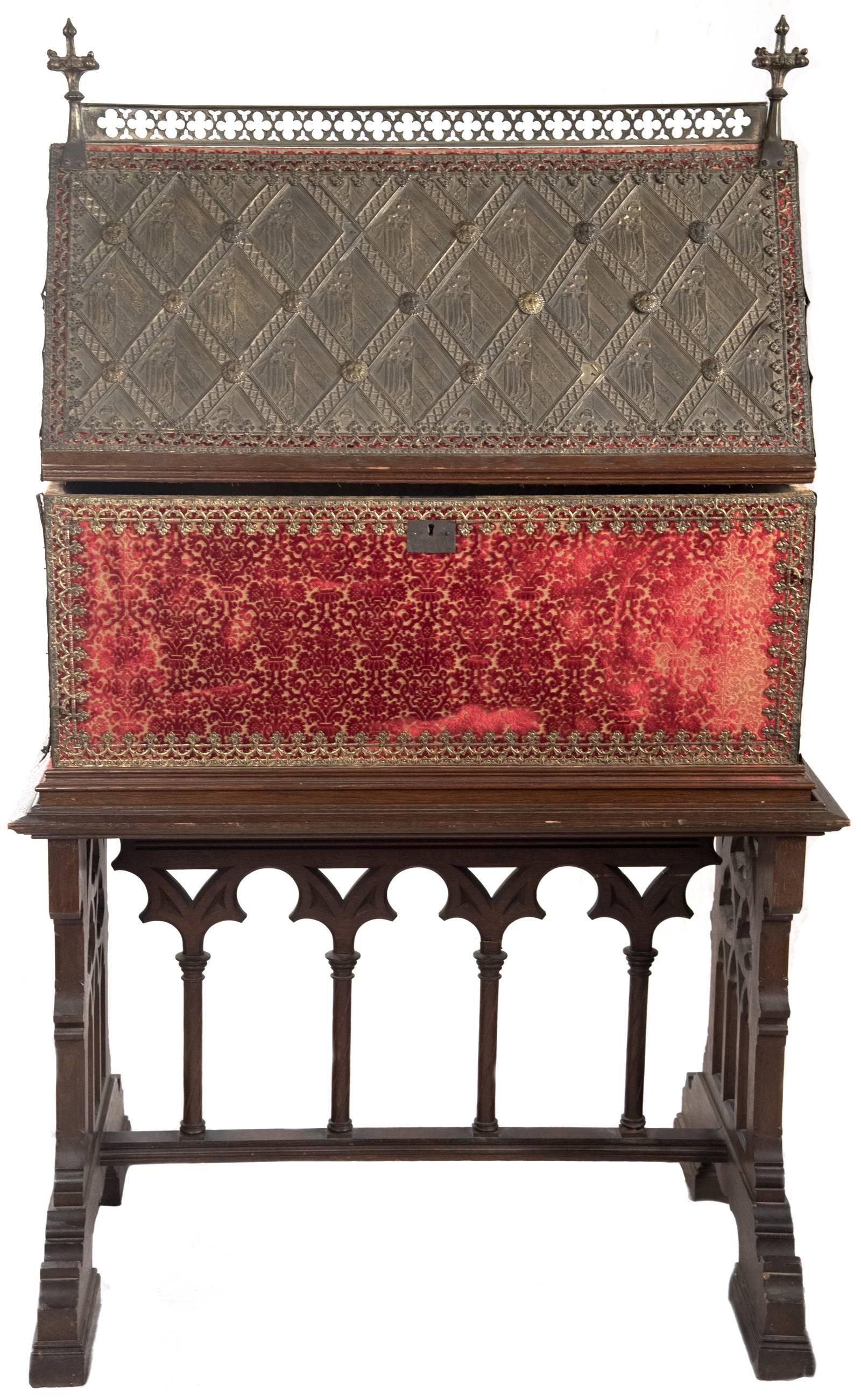 An early 19th century chasse, or box reliquary, its form resembling the architectural structure of a church with an oblong base, straight sides and two sloping faces meeting at a central ridge marked by a raised bronze strip pierced with a repeating