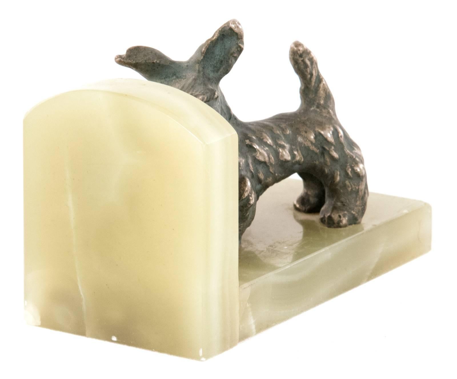 A pair of bookends in the form of bronze Scottish terrier figurines mounted on an onyx base.