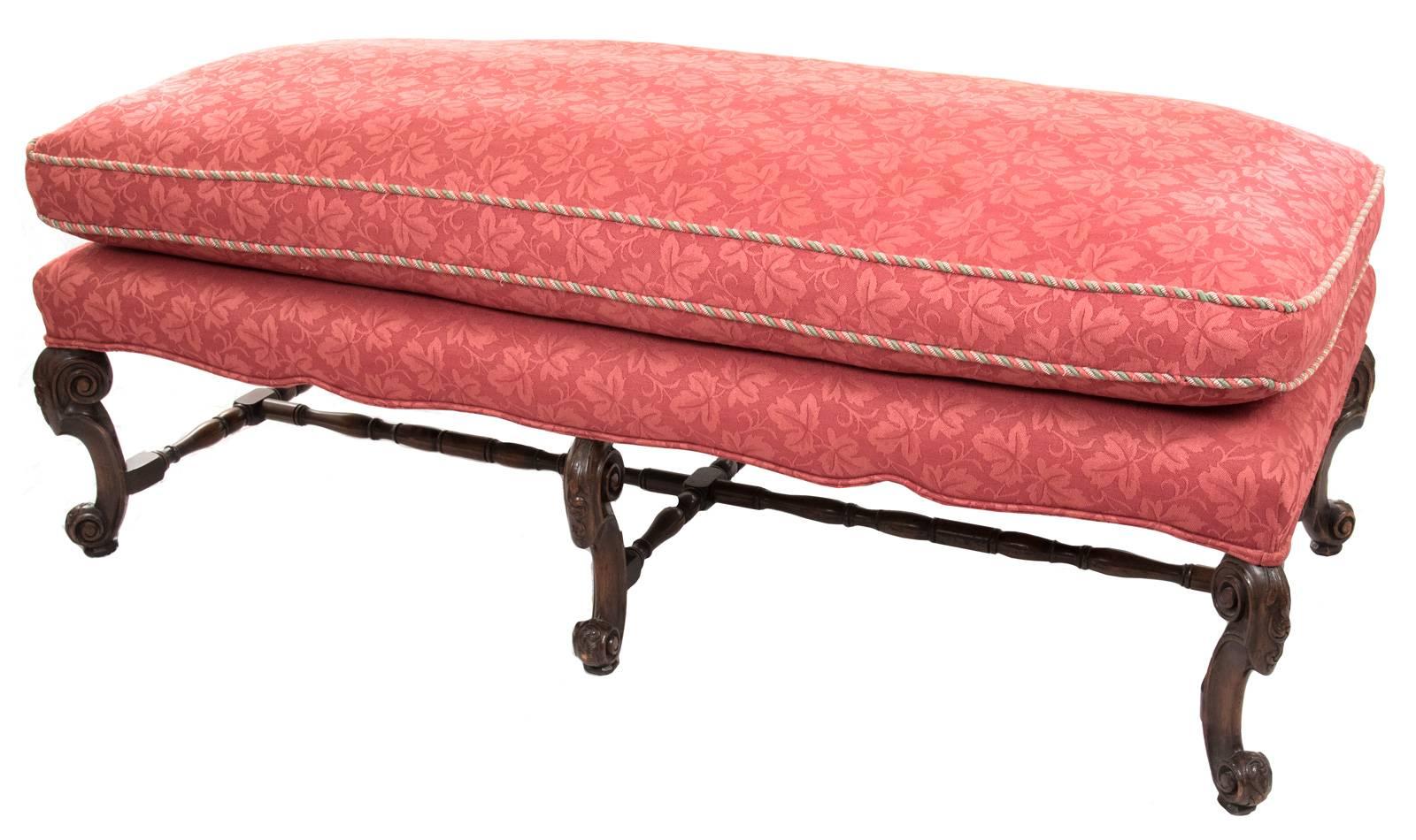A large 18th century carved walnut bench with an overstuffed, removable cushion.