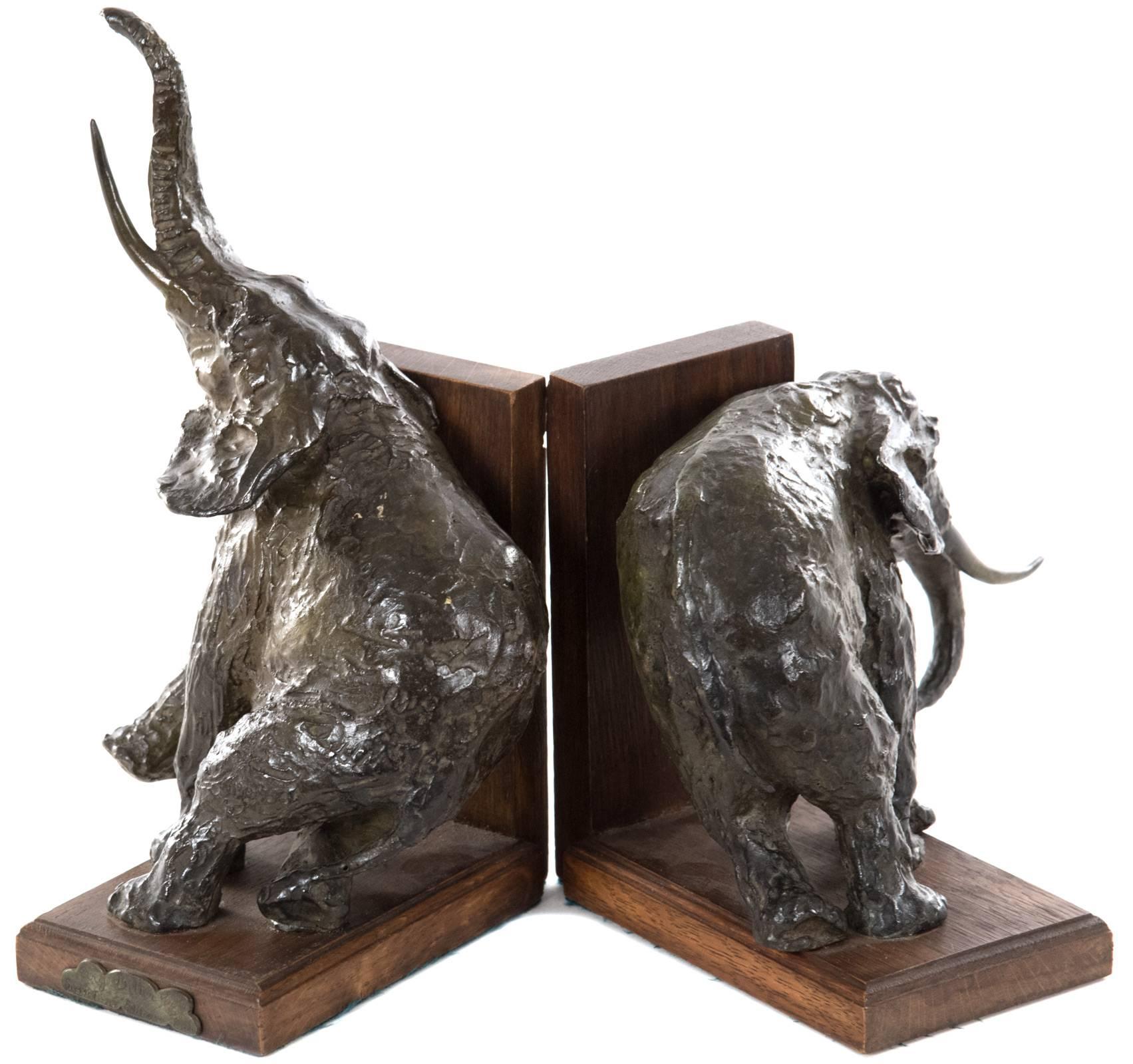A pair of bronze elephant bookends with brown patina mounted on wooden stands by French sculptor Ary Bitter. Engraved “Ary Bitter Sclp Susse Fres Edrs Paris” on bronze plaque on one base. 
Ary Jean Leon Bitter (French, 1883–1973) was a French