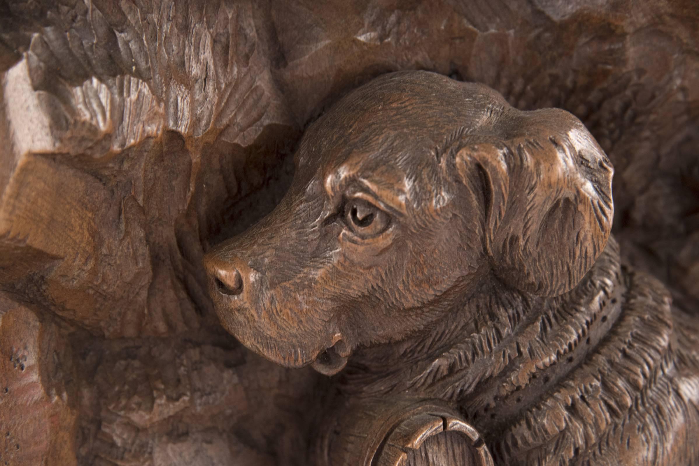 A plaque stippled and carved in deep relief of a rescue dog, a wood barrel around its neck, whose found a young boy in distress, a cross and bird above them. Engraved 