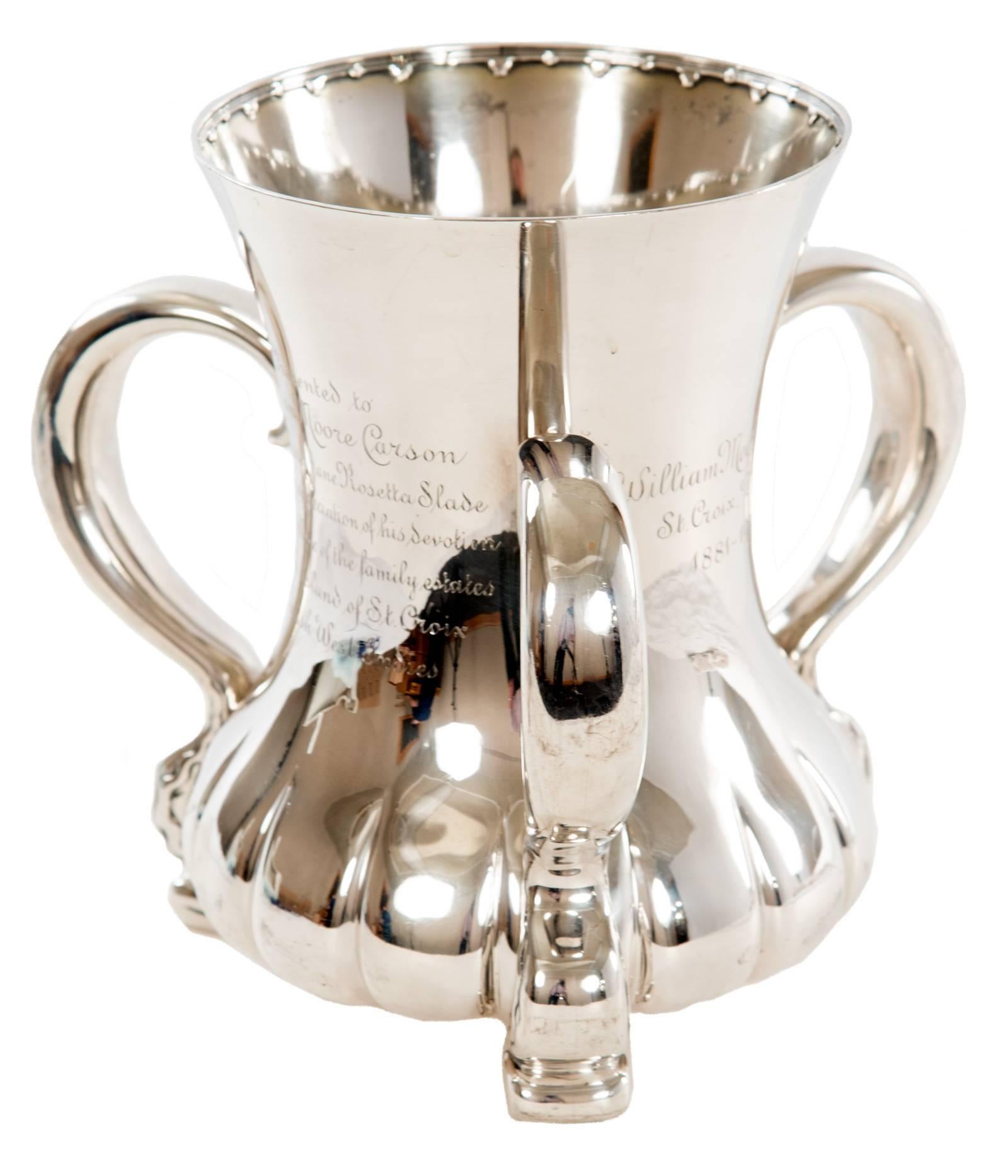 Tiffany & Co sterling silver loving cup with flared base and lip and three applied handles. Inscribed 