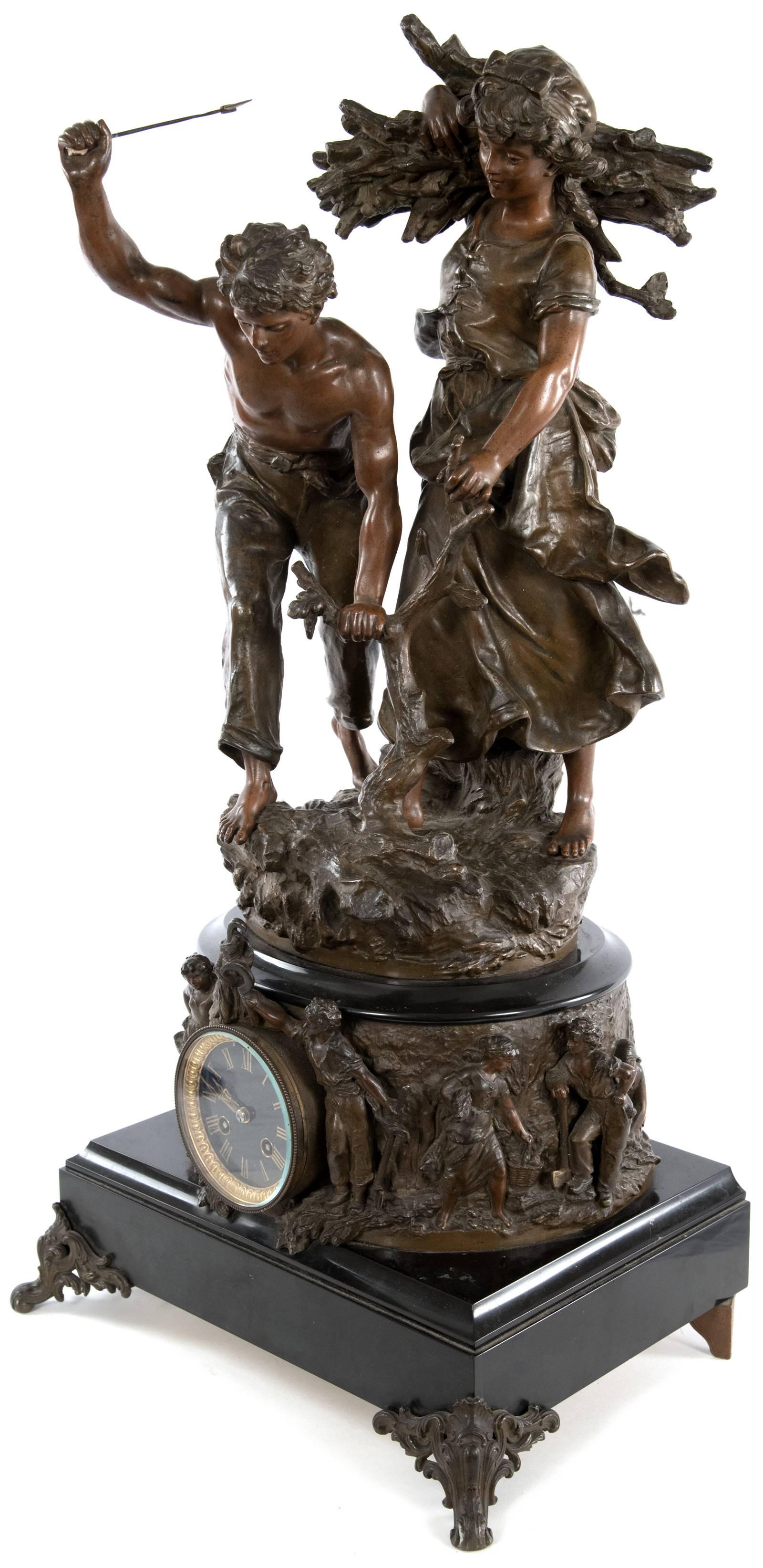 The figures of a young male and female peasant woodcutters, sculpted with exceptional detail and a wonderful sense of movement, are placed upon a naturalistic base on top of the round body of this mantel clock. A round, hand-painted enameled clock