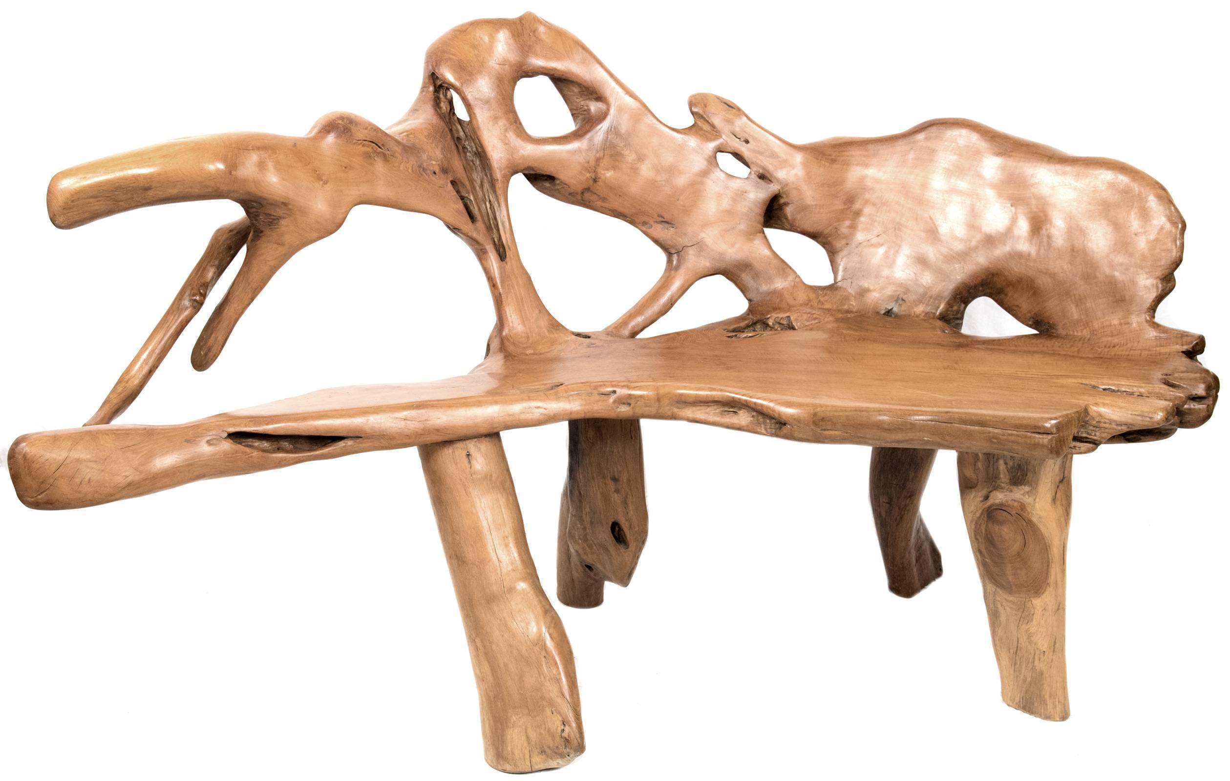 A set of rich, live edge maple chairs and benches that combine both carved and natural branch, root and trunk pieces to create sculptural, yet functional, works with strong organic lines. 
Pieces measure: 
Bench 1: 37 x 73 x 20 in. 
Bench 2: 40 x