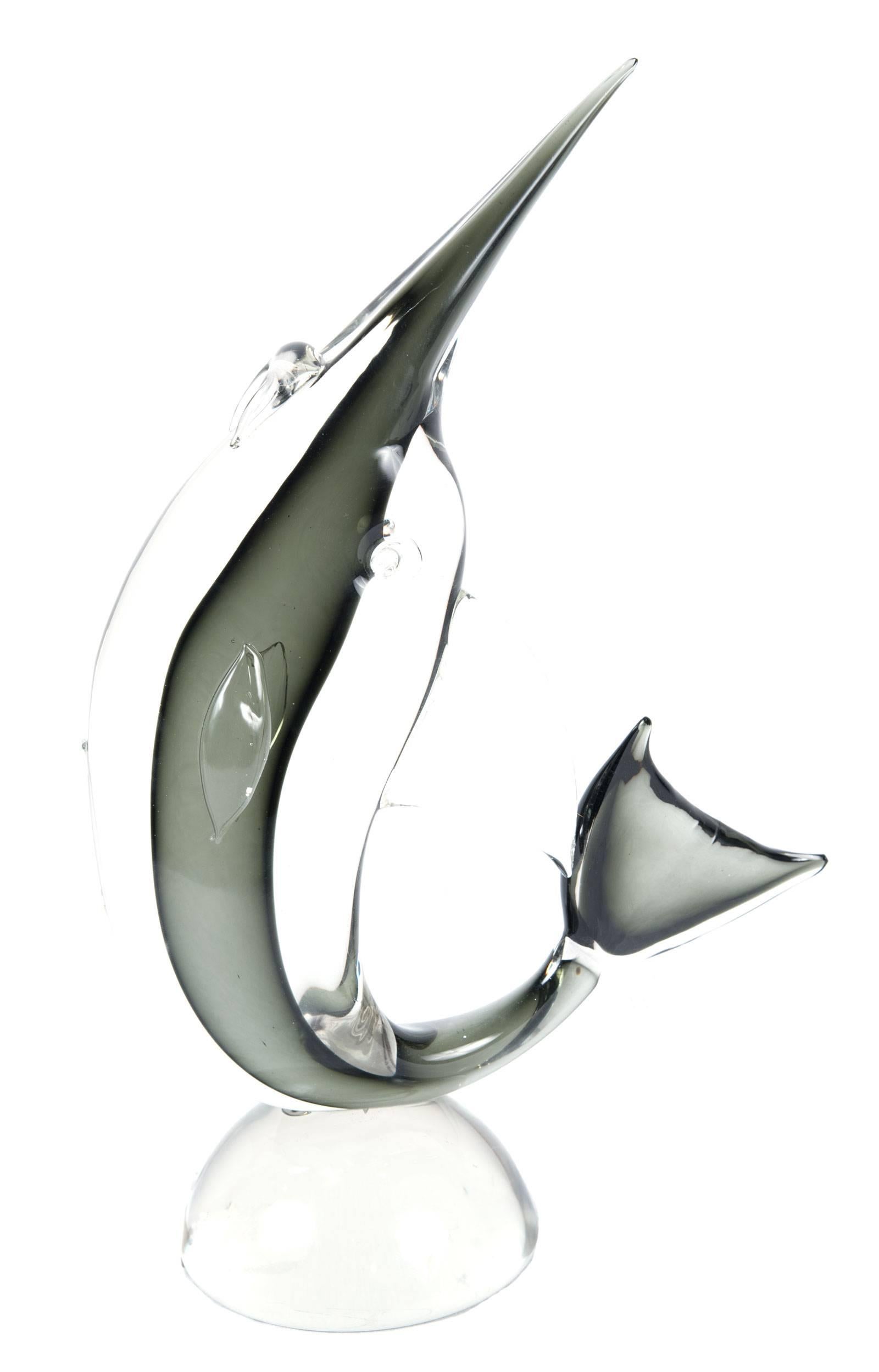 A mid-century Murano glass figure in the form of a swordfish, infused with a grey centre and mounted on a simple dome base.