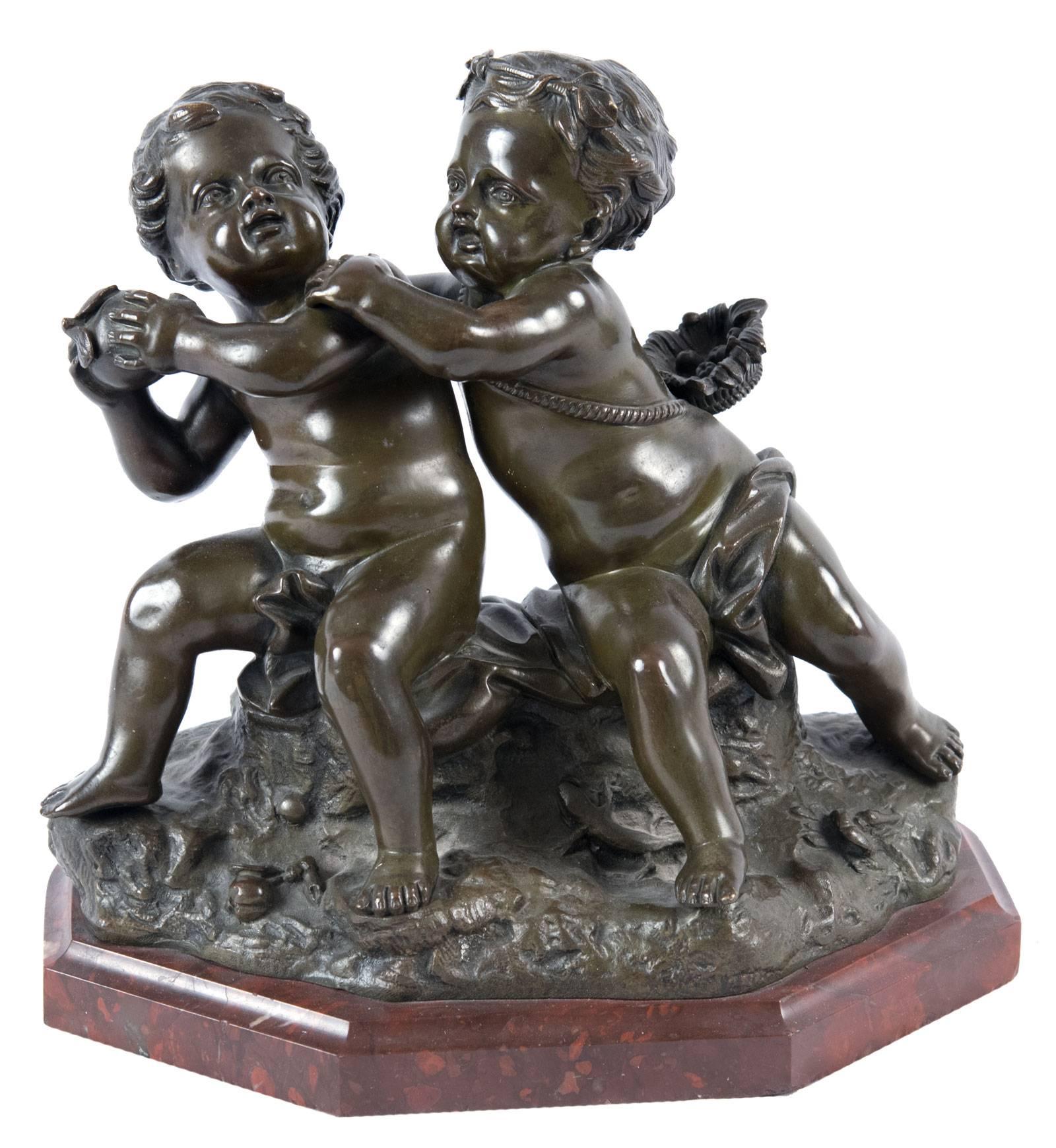 The two putti seated on a draped rockwork base in playful dispute over an apple; one with a basket of fruit at his waist. The grouping mounted on a shaped rouge griotte marble base.

A renowned 17th century sculptor, Jean Baptiste Pigalle