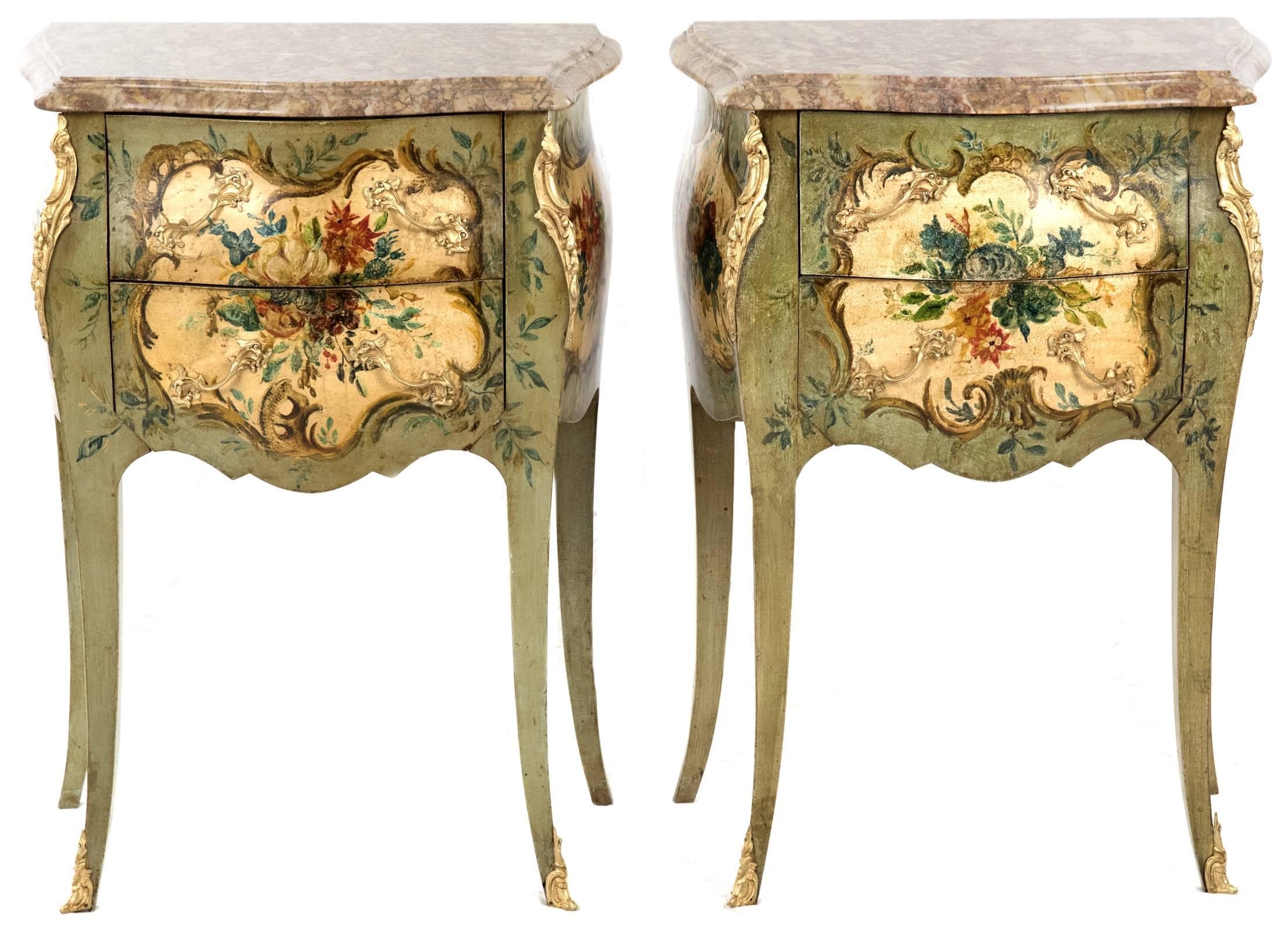 A pair of Rococo Revival bombe shaped nightstands with cases that are beautifully hand-painted with cartouches containing delicate florals and scrolling foliage. The cases have a serpentine-shaped front and curved sides, with each case having two