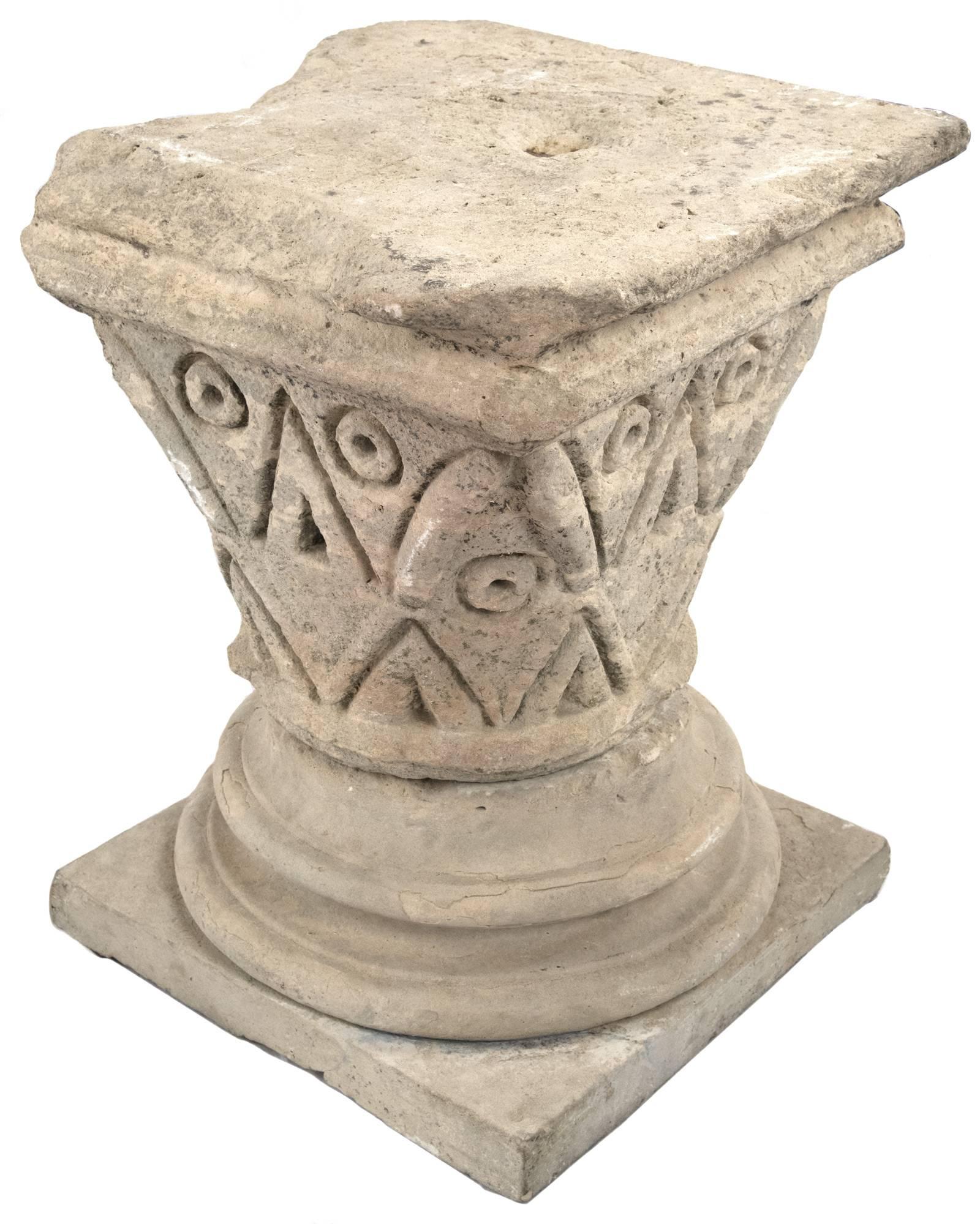 Romanesque pedestal carved from stone with a stepped square top above a tapering body that is deeply carved with geometric shapes, above a tiered round base and square platform. From Normandy, circa 11th-12th Century. Measures: 28 x 21 ½ in.