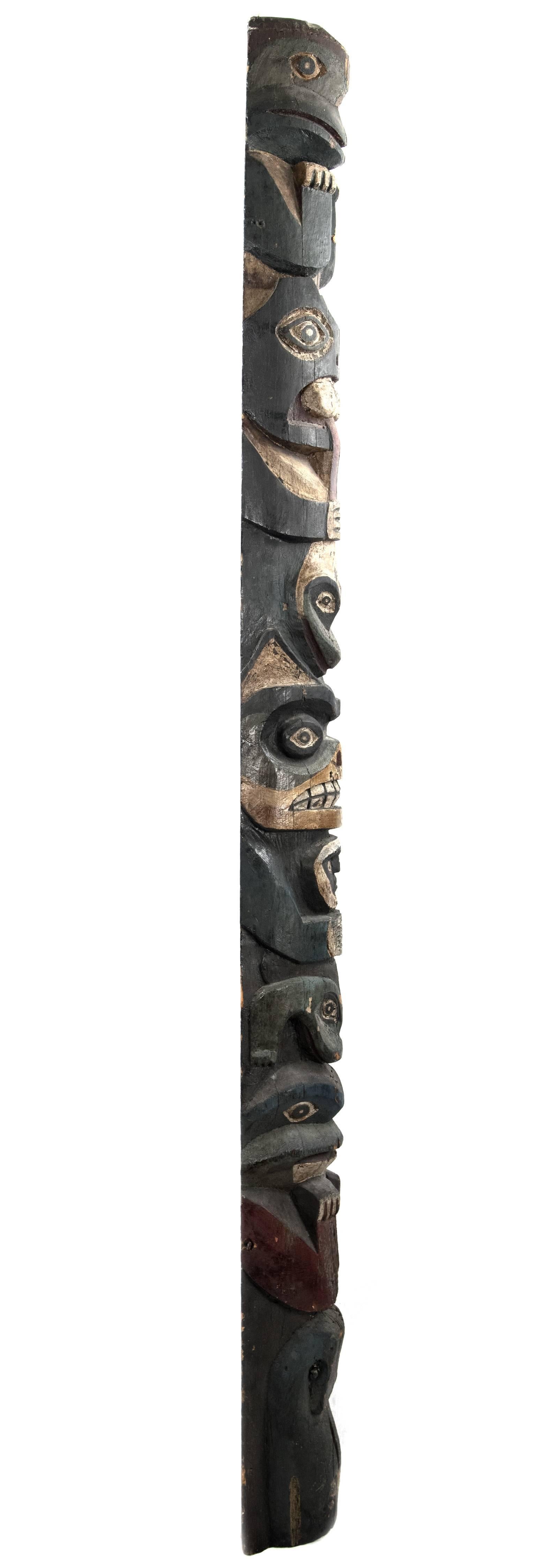A 19th century native American TOTEM pole hand-carved from a single piece of wood with a polychrome painted surface, modeled on various animal and human figures perched on one another. Measures: 84 ½ x 9 ¼ x 6 in.