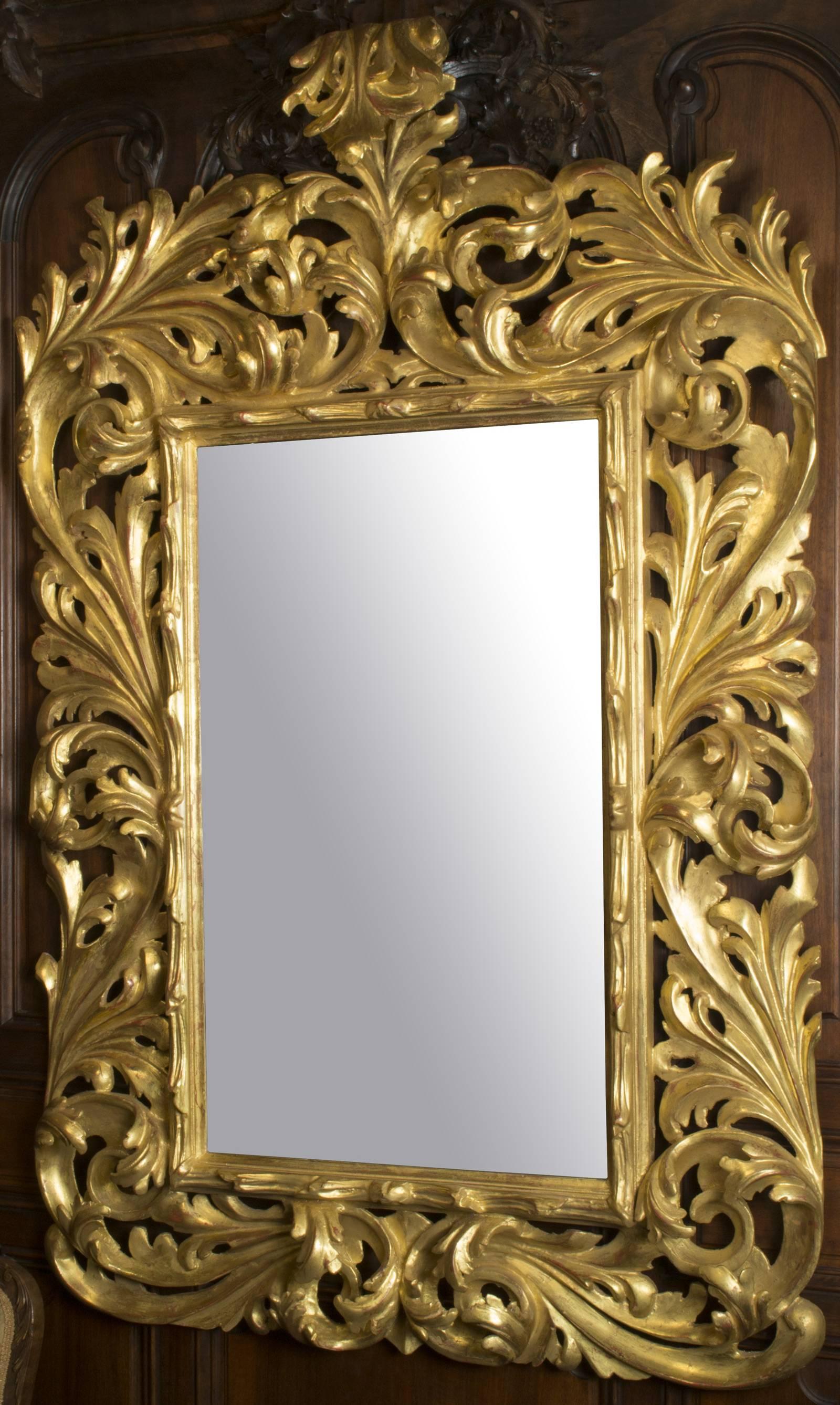 Made in Venice in the mid-nineteenth century, this large mirror is made of carved — not moulded — wood and generously gilt.