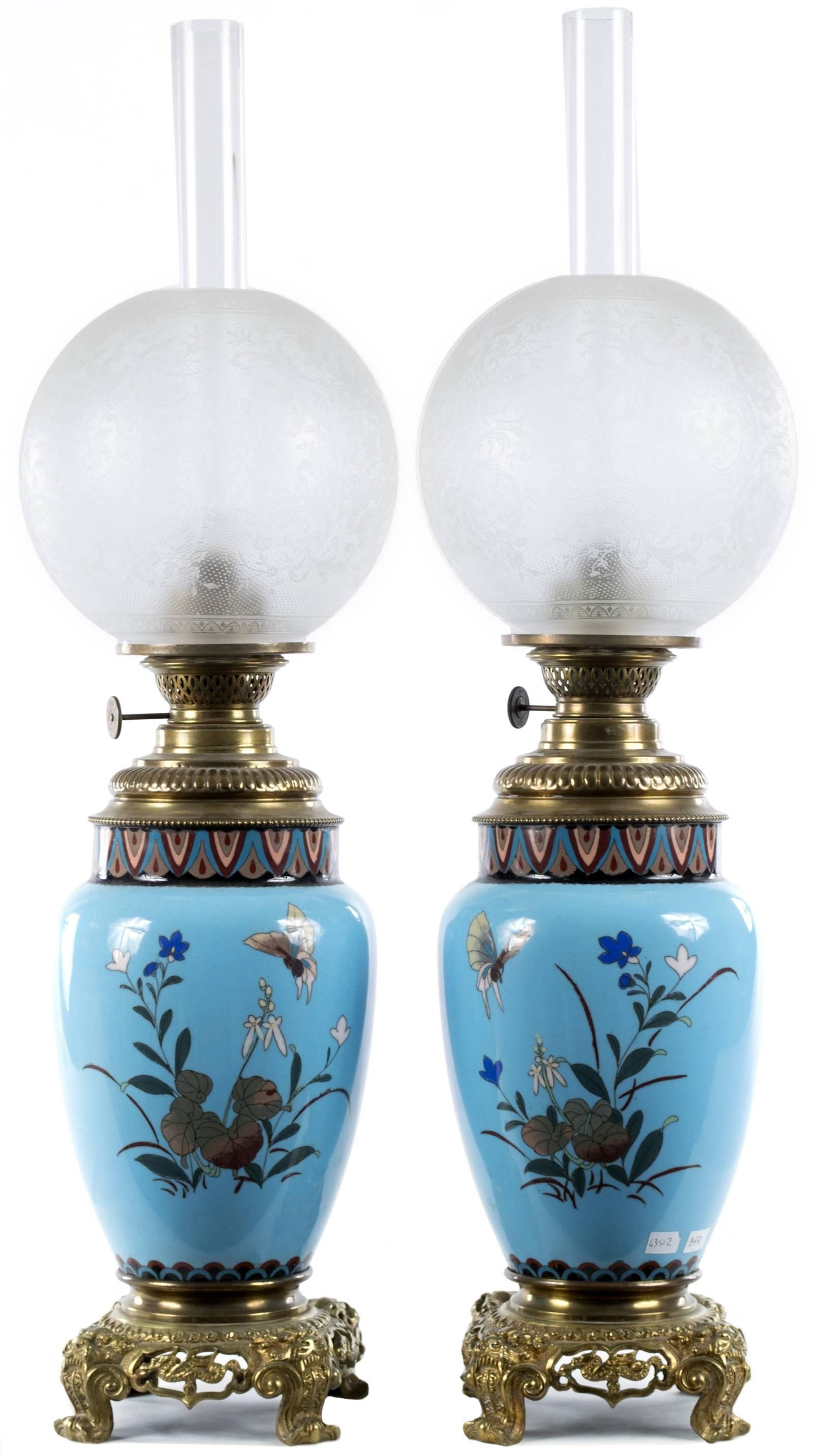 Two beautiful Japanese vases, dating to the third quarter of the nineteenth century and featuring birds flying through cherry blossoms. The lamps were fitted with gilt bronze (i.e. ormolu) mounts and etched glass oil lamps before the turn of the