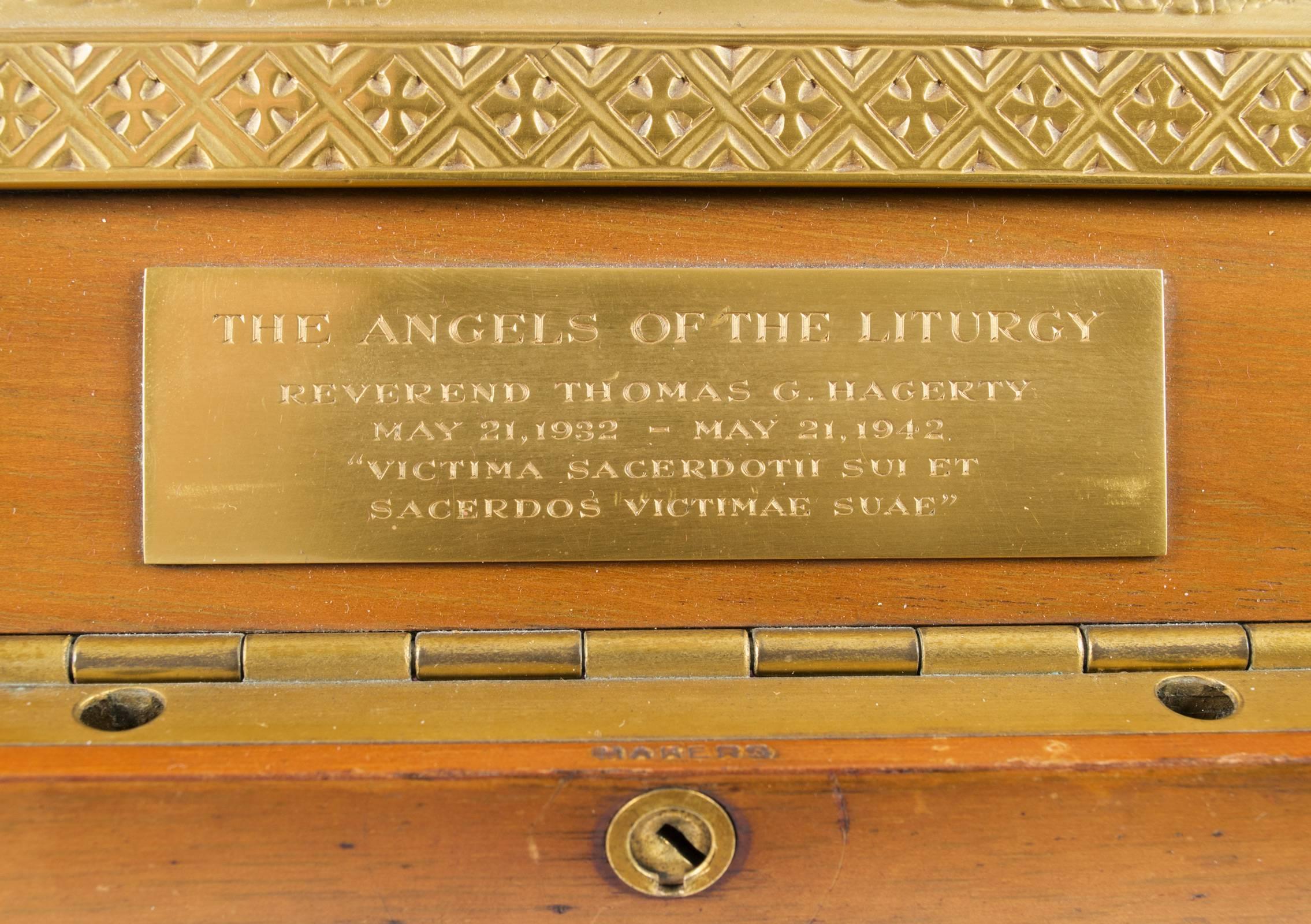 Made in 1942, this gilt and silvered plaque, features eleven angels carrying the instruments of the Catholic Mass, and is encased in a purpose-made walnut box lined with velvet and stamped by the maker, Tiffany and Company. The sculpture was a gift