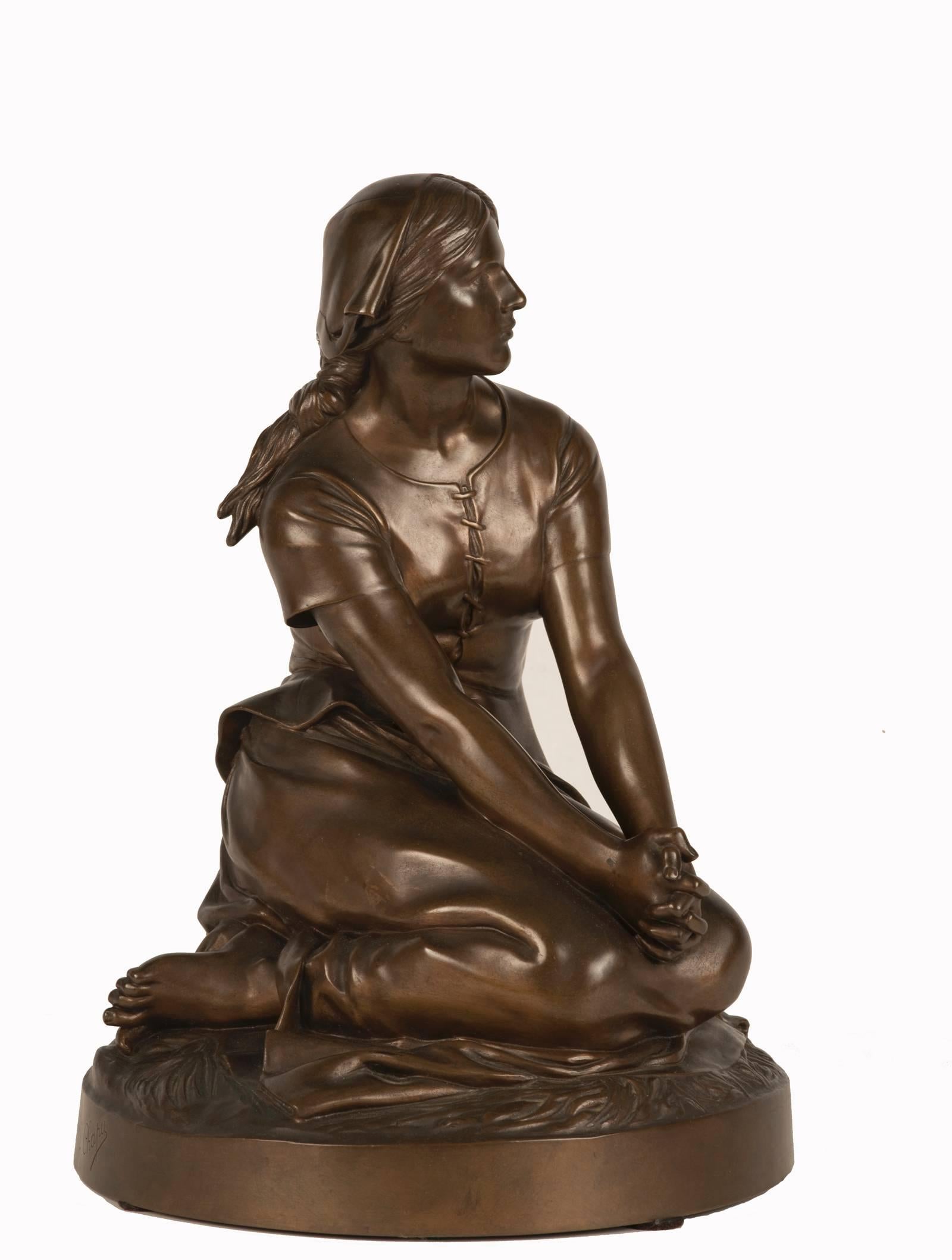 
An elegantly sculpted Joan of Arc, depicted as an unadorned Lorraine shepherdess, sits with her hands clasped in prayer. This simple representation juxtaposes the mythic stature of the heroine as an enduring symbol of French nationalism. Yet it is