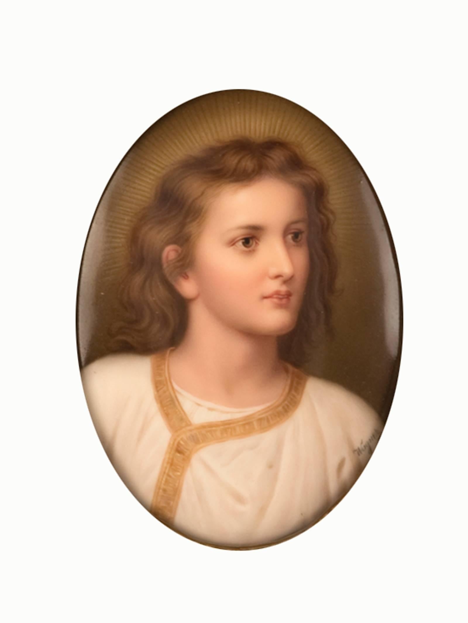 
This ethereal portrait of a Christ as a young boy is hand-painted on an oval-shaped porcelain plaque that sits within an elaborate rectangular carved and giltwood frame. This KMP plaque is after Heinrich Hofmann’s 1881 painting “Jesus in the